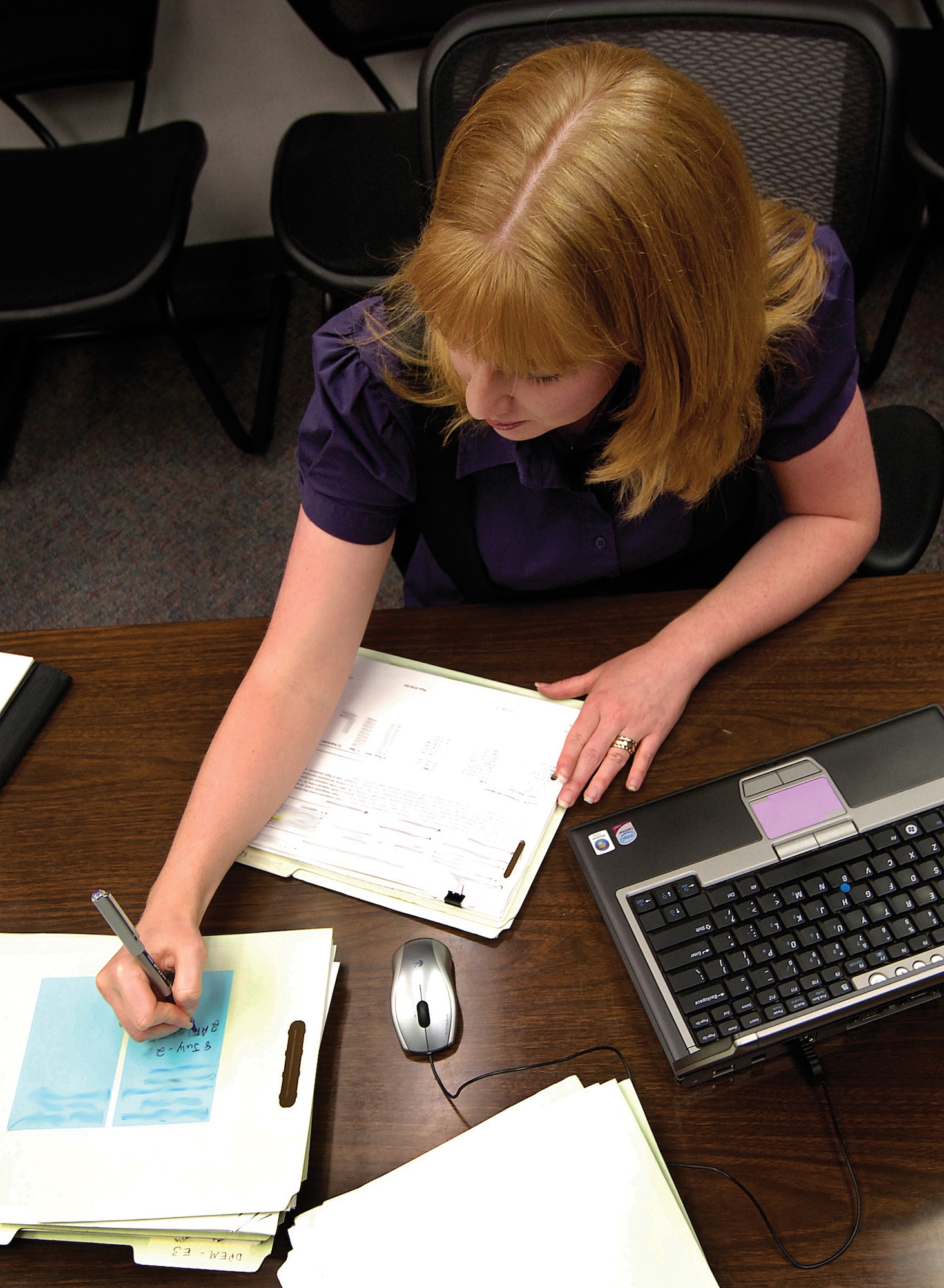 Auditor Michelle Bennett pours over software maintenance requirements from weapons systems.  The Air Force Audit Agency here performs audits on any Tinker entity as requested and by centrally directed audit requests that originate from the Pentagon, all with the goal of improvement.(Air Force photo by Margo Wright)