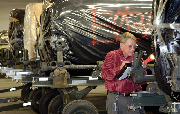 In a Bldg. 3 warehouse, auditor John Tulp verifies the serial number of an F101/102 engine. Mr Tulp will verify if an engine listed at Tinker is actually here and helps agencies manage their assets by these requested audits. Personnel learn the auditors are helping and not hunting for faults.  “They realize we’re auditing processes, not people,” said Mr. Tulp.