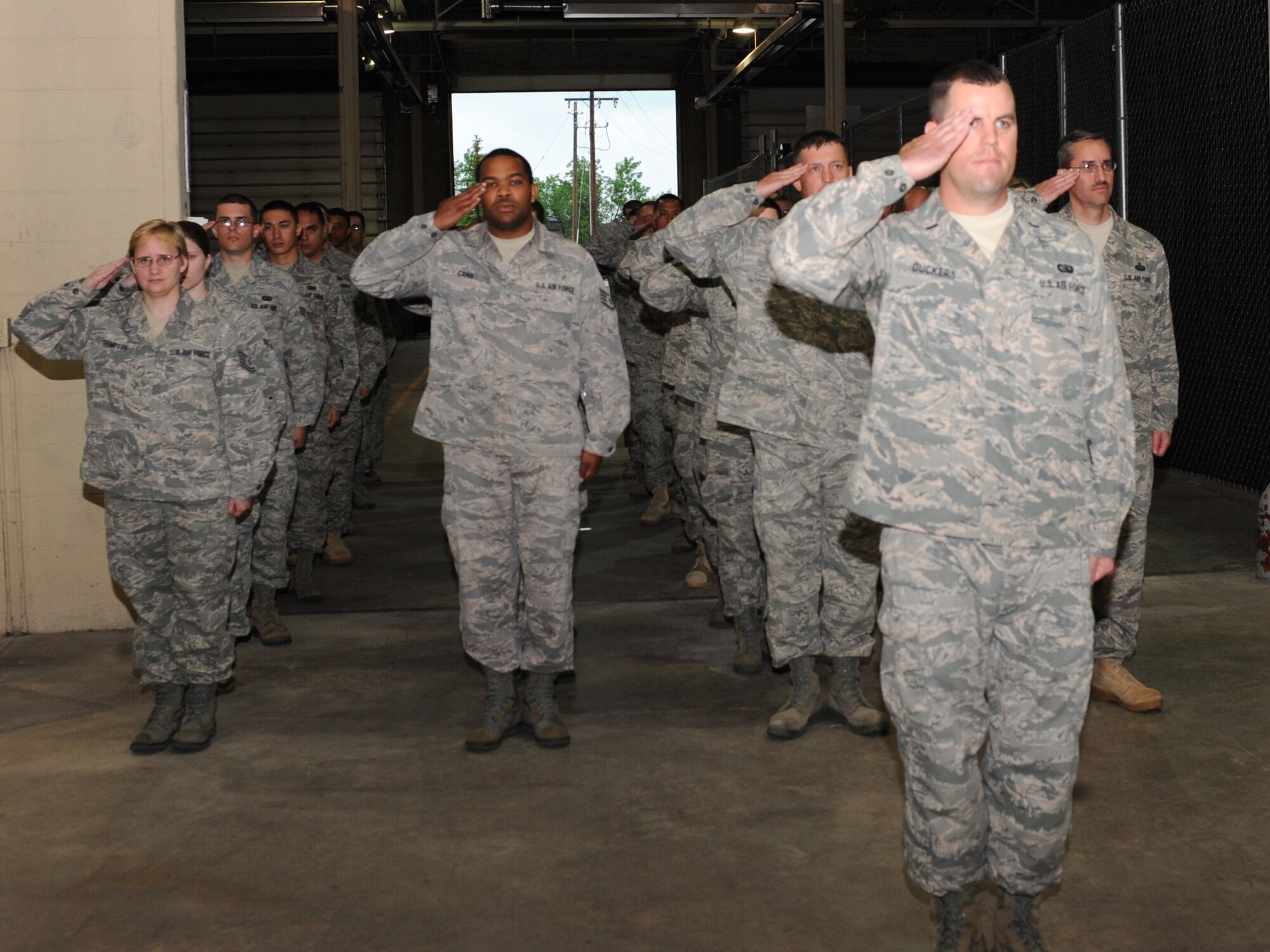 Airmen from the 319th Communications Squadron give a final salute to Lt. Col. Samuel Bass during the change-of –command ceremony, June 17 at the 319 CS building. Lt. Col. Joseph Moritz assumed command of the squadron from Colonel Bass. (U.S. Air Force photo by Airman 1st Class Amber Price)
