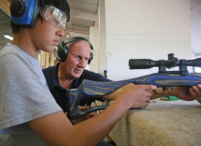 Former Marine Corps marksmanship trainer Ken Caudle, right, gives some .22 rifle instruction to James Gallaher, 14, during a recent Tinker Shooting Club gathering. Gallaher’s father, Willard, works at Tinker and said the club has given his family a great start into the sport of shooting. (Air Force photo by John Stuart)