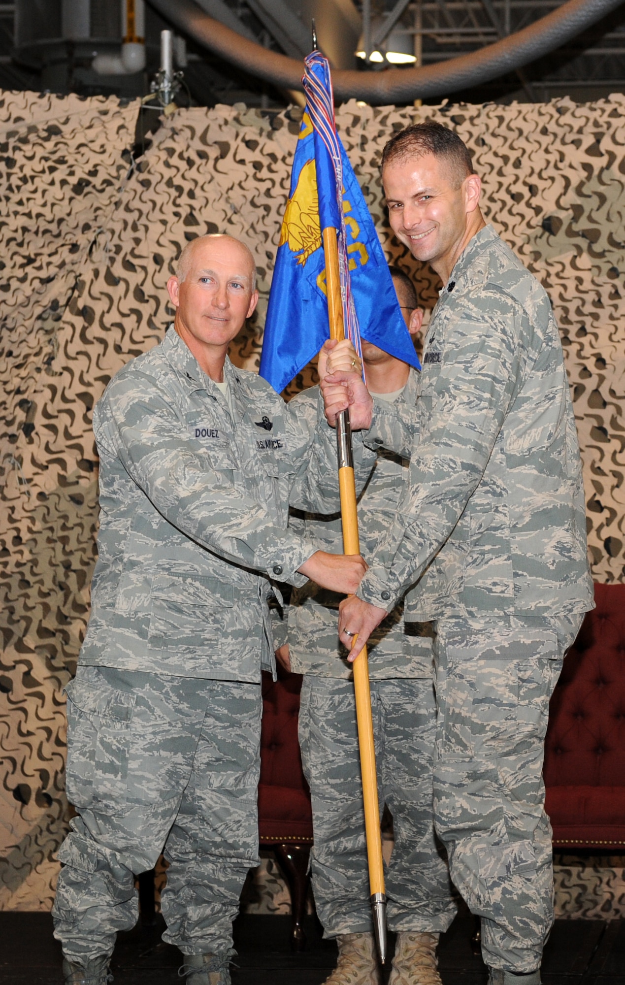 Lt. Col. Joseph Moritz (right) assumes command of the 319th Communications Squadron from Col. Joseph Douez, 319th Mission Support Group commander, during the change-of-command ceremony, June 17 at the 319 CS building. Colonel Moritz assumed command of the 319 CS from Lt. Col. Samuel Bass. (U.S. Air Force photo by Airman 1st Class Amber Price)
