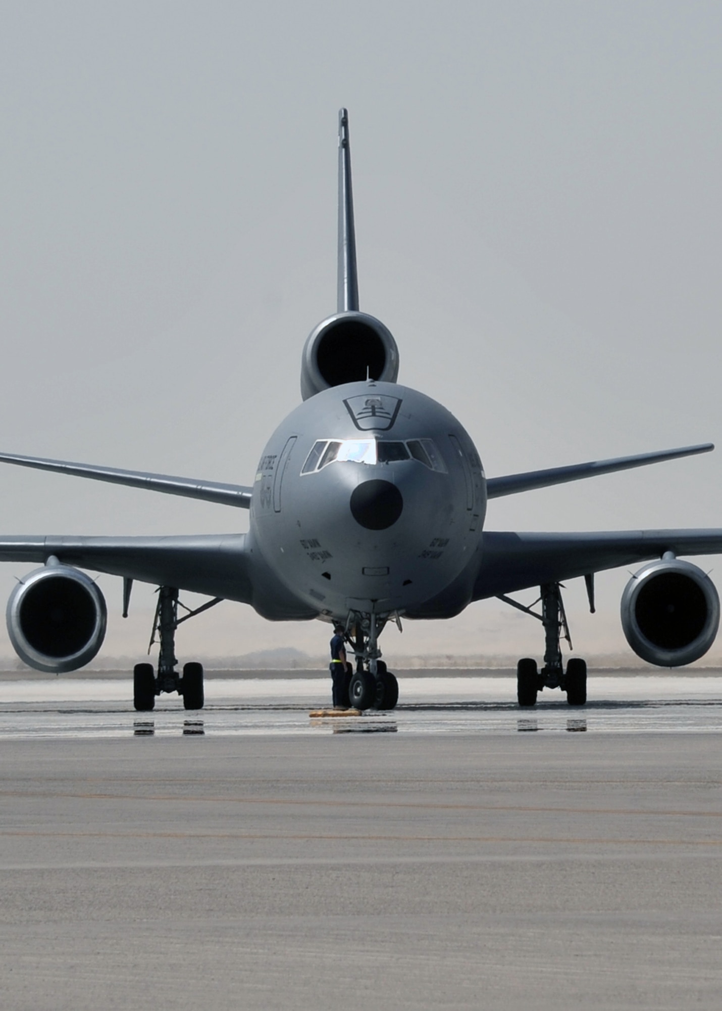 A flight crew from the 908th Expeditionary Air Refueling Squadron guides a KC-10 Extender, also from the 908th EARS, to a parking area at a non-disclosed base in Southwest Asia on June 2, 2010. According to statistics from Mr. Yancy Mailes, 380th AEW historian, KC-10s assigned to the 908th EARS and the Airmen who support and fly them flew more than 230 missions off-loading nearly 35 million pounds of fuel to more than 2,100 aircraft from January through April 2010. The 908th EARS, as part of the 380th Air Expeditionary Wing, supports operations Iraqi Freedom, Enduring Freedom, and the Combined Joint Task Force-Horn of Africa. The 908th EARS is a sub-unit of the 380th Air Expeditionary Wing. In addition to the KC-10 Extender, the 380th AEW is home to the U-2 Dragon Lady, E-3 Sentry and RQ-4 Global Hawk aircraft. The wing is comprised of four groups and 12 squadrons and the wing's deployed mission includes air refueling, surveillance and reconnaissance in support of overseas contingency operations in Southwest Asia. (U.S. Air Force Photo/Master Sgt. Scott T. Sturkol/Released)