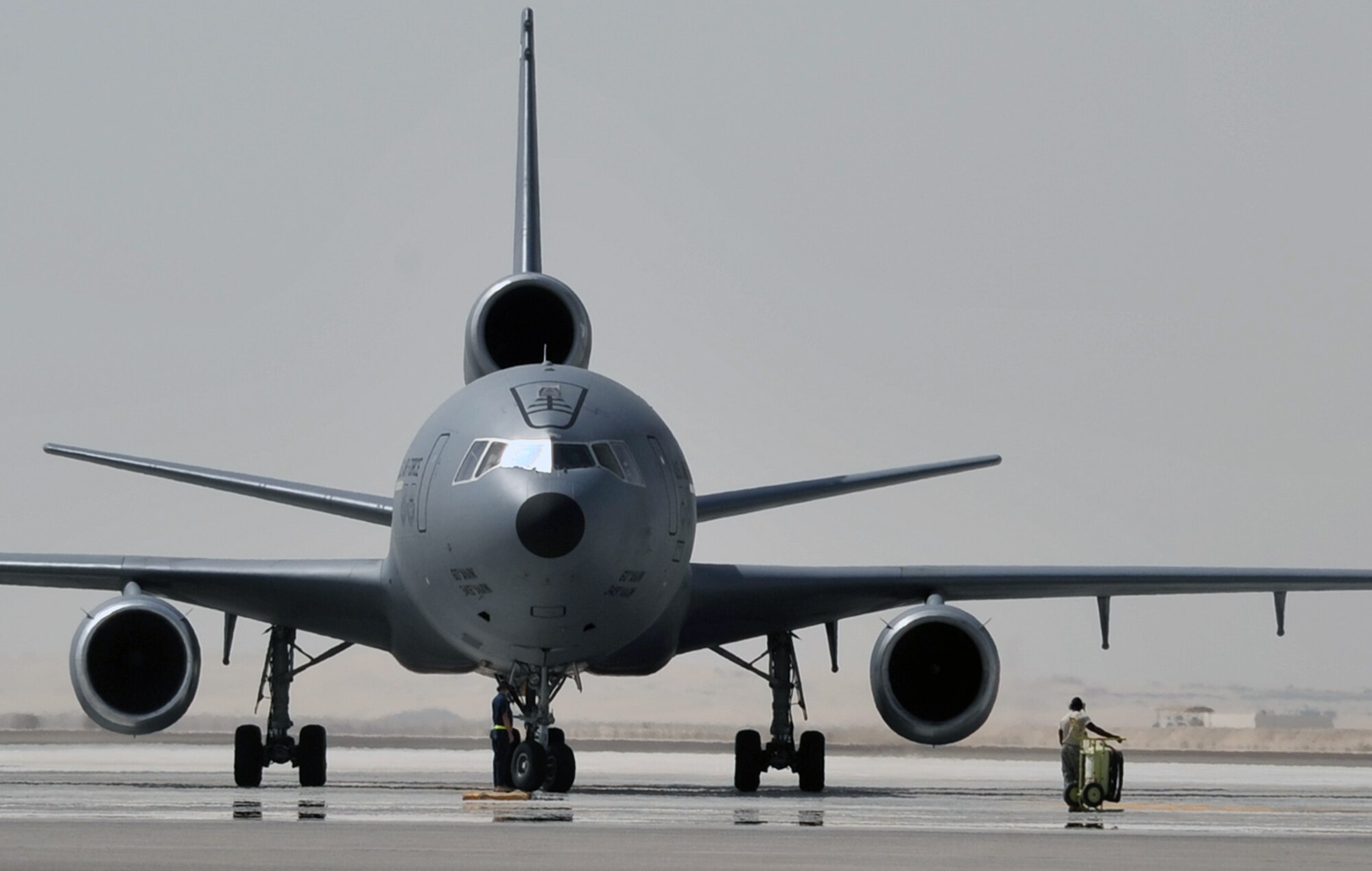 A flight crew from the 908th Expeditionary Air Refueling Squadron guides a KC-10 Extender, also from the 908th EARS, to a parking area at a non-disclosed base in Southwest Asia on June 2, 2010. According to statistics from Mr. Yancy Mailes, 380th AEW historian, KC-10s assigned to the 908th EARS and the Airmen who support and fly them flew more than 230 missions off-loading nearly 35 million pounds of fuel to more than 2,100 aircraft from January through April 2010. The 908th EARS, as part of the 380th Air Expeditionary Wing, supports operations Iraqi Freedom, Enduring Freedom, and the Combined Joint Task Force-Horn of Africa. The 908th EARS is a sub-unit of the 380th Air Expeditionary Wing. In addition to the KC-10 Extender, the 380th AEW is home to the U-2 Dragon Lady, E-3 Sentry and RQ-4 Global Hawk aircraft. The wing is comprised of four groups and 12 squadrons and the wing's deployed mission includes air refueling, surveillance and reconnaissance in support of overseas contingency operations in Southwest Asia. (U.S. Air Force Photo/Master Sgt. Scott T. Sturkol/Released)