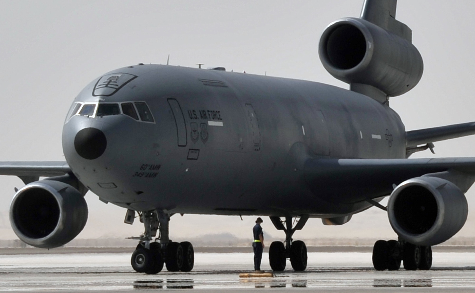 A flight crew from the 908th Expeditionary Air Refueling Squadron guides a KC-10 Extender, also from the 908th EARS, to a parking area at a non-disclosed base in Southwest Asia on June 2, 2010. According to statistics from Mr. Yancy Mailes, 380th AEW historian, KC-10s assigned to the 908th EARS and the Airmen who support and fly them flew more than 230 missions off-loading nearly 35 million pounds of fuel to more than 2,100 aircraft from January through April 2010. The 908th EARS, as part of the 380th Air Expeditionary Wing, supports operations Iraqi Freedom, Enduring Freedom, and the Combined Joint Task Force-Horn of Africa. The 908th EARS is a sub-unit of the 380th Air Expeditionary Wing. In addition to the KC-10 Extender, the 380th AEW is home to the U-2 Dragon Lady, E-3 Sentry and RQ-4 Global Hawk aircraft. The wing is comprised of four groups and 12 squadrons and the wing's deployed mission includes air refueling, surveillance and reconnaissance in support of overseas contingency operations in Southwest Asia. (U.S. Air Force Photo/Master Sgt. Scott T. Sturkol/Released)