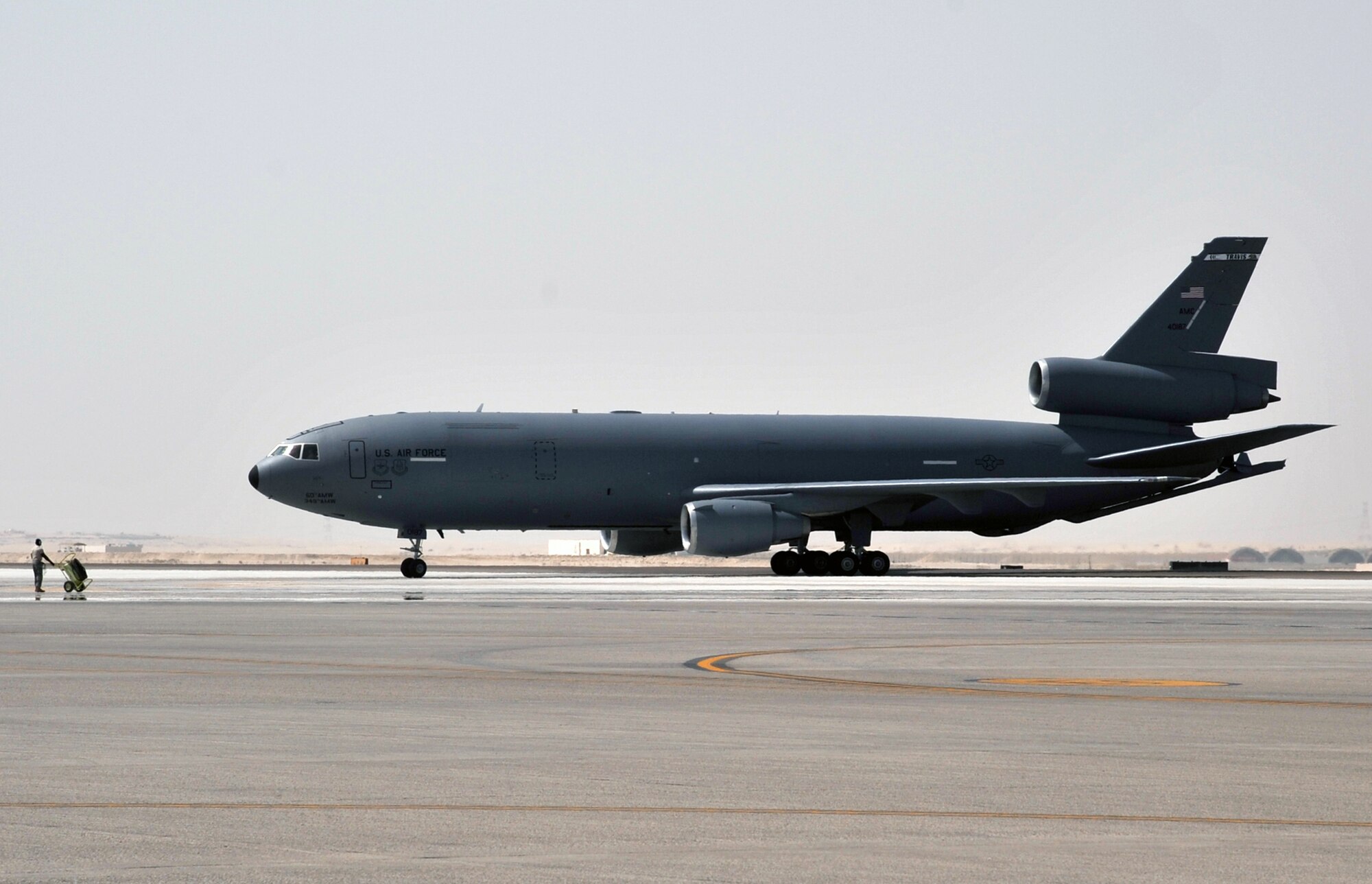 A flight crew from the 908th Expeditionary Air Refueling Squadron guides a KC-10 Extender, also from the 908th EARS, to a parking area at a non-disclosed base in Southwest Asia on June 2, 2010. According to statistics from Mr. Yancy Mailes, 380th AEW historian, KC-10s assigned to the 908th EARS and the Airmen who support and fly them flew more than 230 missions off-loading nearly 35 million pounds of fuel to more than 2,100 aircraft from January through April 2010. The 908th EARS, as part of the 380th Air Expeditionary Wing, supports operations Iraqi Freedom, Enduring Freedom, and the Combined Joint Task Force-Horn of Africa. The 908th EARS is a sub-unit of the 380th Air Expeditionary Wing. In addition to the KC-10 Extender, the 380th AEW is home to the U-2 Dragon Lady, E-3 Sentry and RQ-4 Global Hawk aircraft. The wing is comprised of four groups and 12 squadrons and the wing's deployed mission includes air refueling, surveillance and reconnaissance in support of overseas contingency operations in Southwest Asia. (U.S. Air Force Photo/Master Sgt. Scott T. Sturkol/Released)