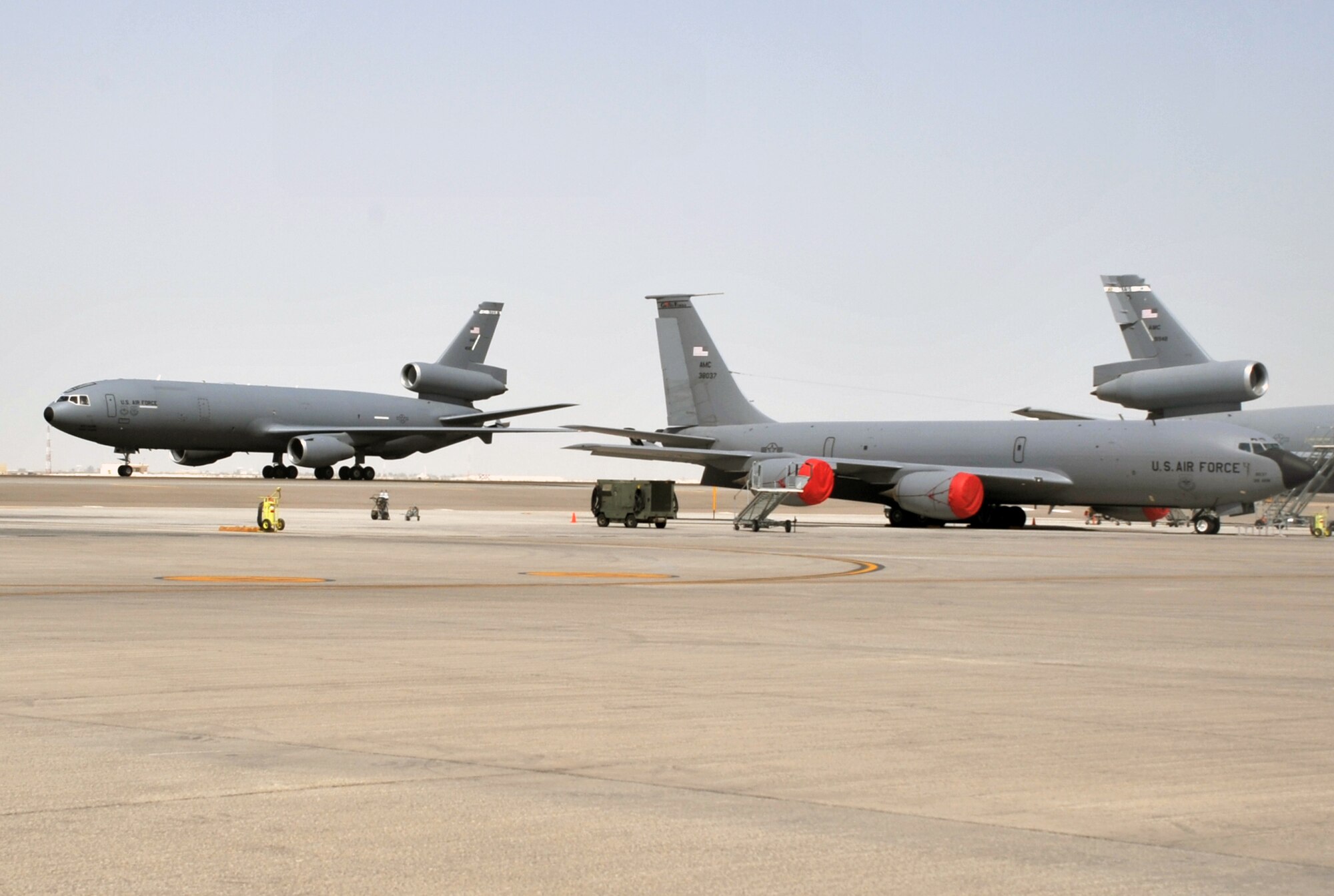 A KC-135R Stratotanker deployed from Grand Forks Air Force Base, N.D., and a KC-10 Extender deployed from Travis AFB, Calif., are seen on the flightline operations area for the 380th Air Expeditionary Wing at a non-disclosed base in Southwest Asia on June 2, 2010. Both airframes support deployed air refueling efforts through the 908th Expeditionary Air Refueling Squadron. The 908th EARS, as part of the 380th Air Expeditionary Wing, supports operations Iraqi Freedom, Enduring Freedom, and the Combined Joint Task Force-Horn of Africa. The 908th EARS is a sub-unit of the 380th Air Expeditionary Wing. (U.S. Air Force Photo/Master Sgt. Scott T. Sturkol/Released)