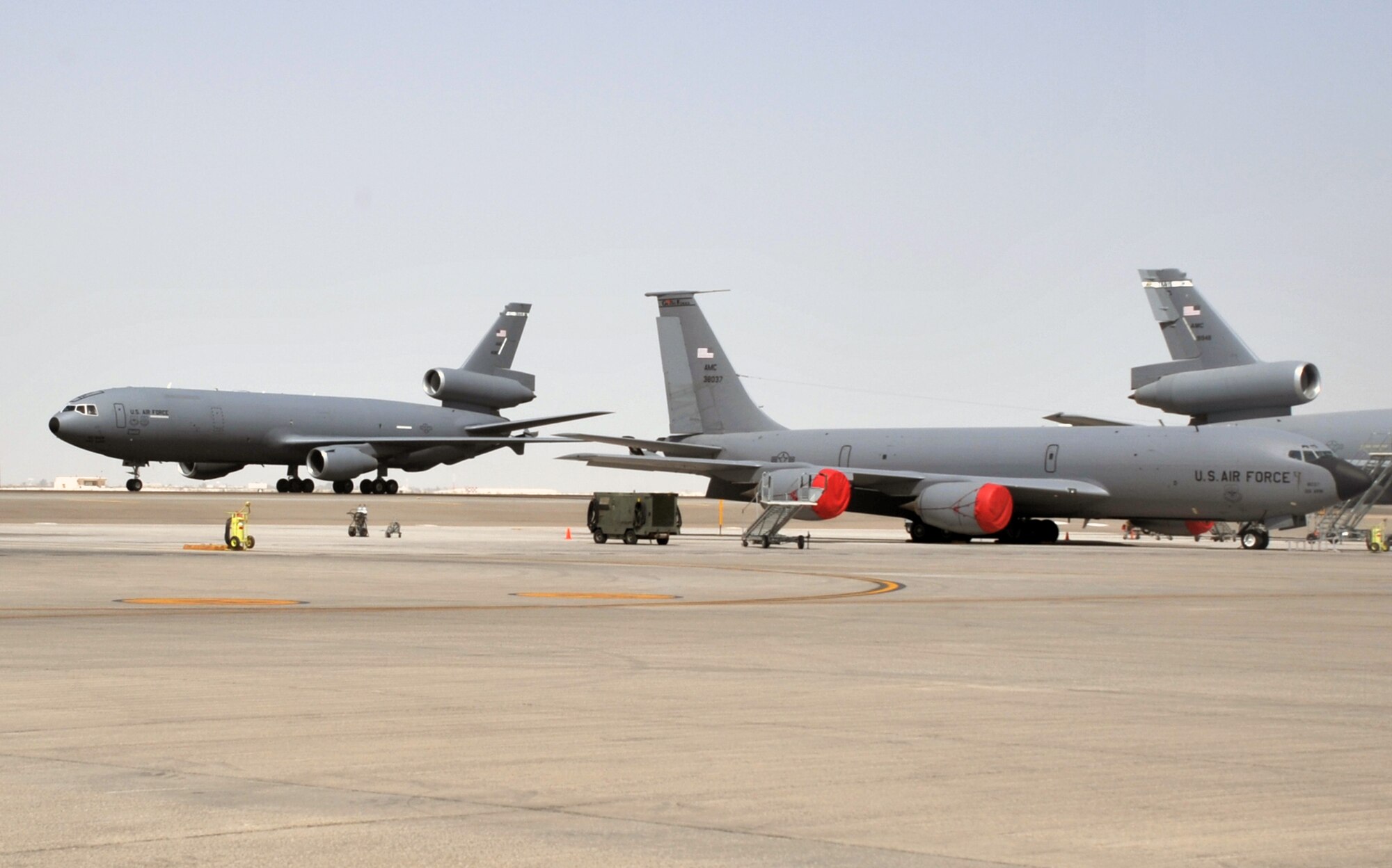 A KC-135R Stratotanker deployed from Grand Forks Air Force Base, N.D., and a KC-10 Extender deployed from Travis AFB, Calif., are seen on the flightline operations area for the 380th Air Expeditionary Wing at a non-disclosed base in Southwest Asia on June 2, 2010. Both airframes support deployed air refueling efforts through the 908th Expeditionary Air Refueling Squadron. The 908th EARS, as part of the 380th Air Expeditionary Wing, supports operations Iraqi Freedom, Enduring Freedom, and the Combined Joint Task Force-Horn of Africa. The 908th EARS is a sub-unit of the 380th Air Expeditionary Wing. (U.S. Air Force Photo/Master Sgt. Scott T. Sturkol/Released)