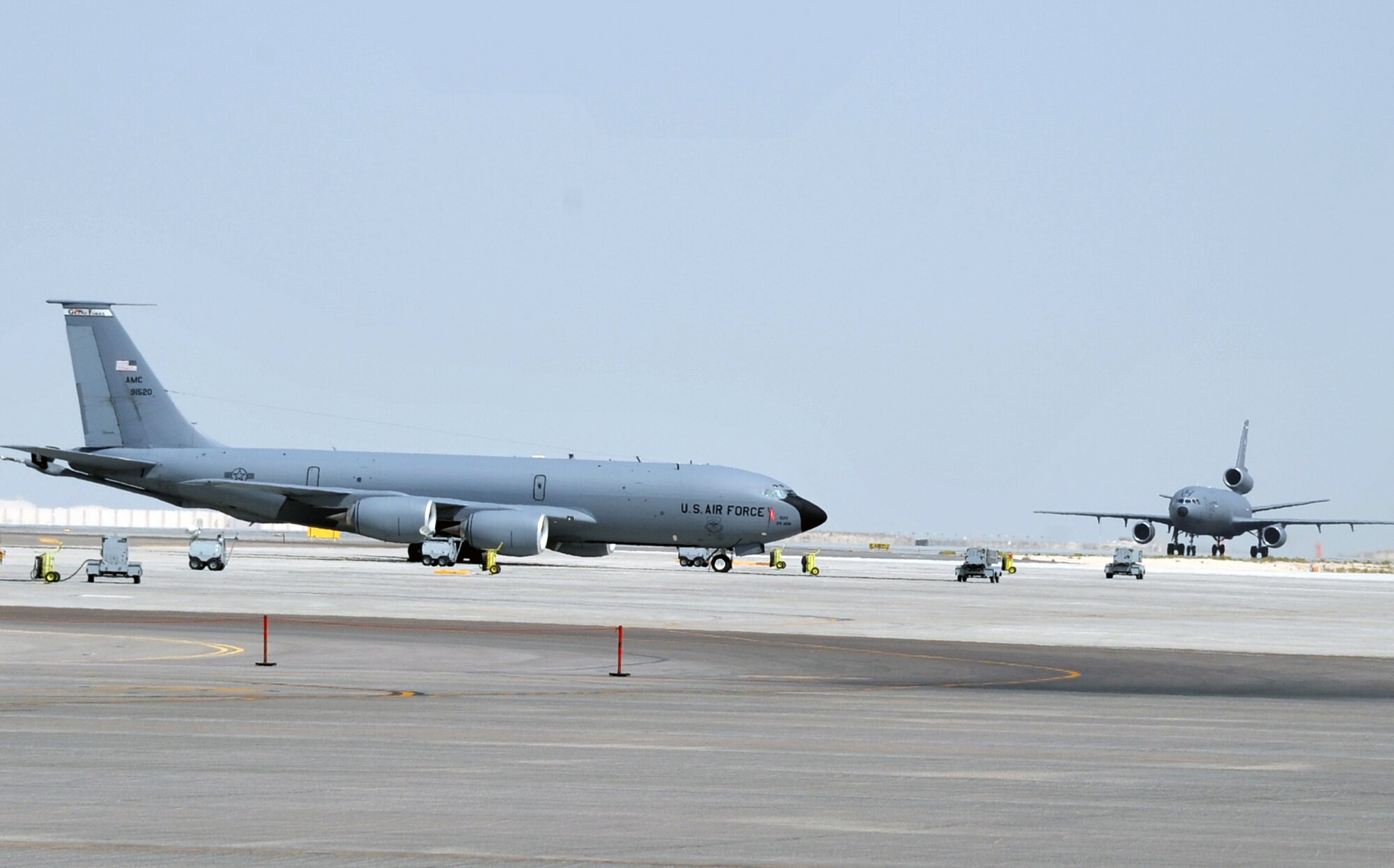A KC-135R Stratotanker deployed from Grand Forks Air Force Base, N.D., and a KC-10 Extender deployed from Travis AFB, Calif., are parked on the flightline operations area for the 380th Air Expeditionary Wing at a non-disclosed base in Southwest Asia on June 2, 2010. Both airframes support deployed air refueling efforts through the 908th Expeditionary Air Refueling Squadron. The 908th EARS, as part of the 380th Air Expeditionary Wing, supports operations Iraqi Freedom, Enduring Freedom, and the Combined Joint Task Force-Horn of Africa. The 908th EARS is a sub-unit of the 380th Air Expeditionary Wing. (U.S. Air Force Photo/Master Sgt. Scott T. Sturkol/Released)