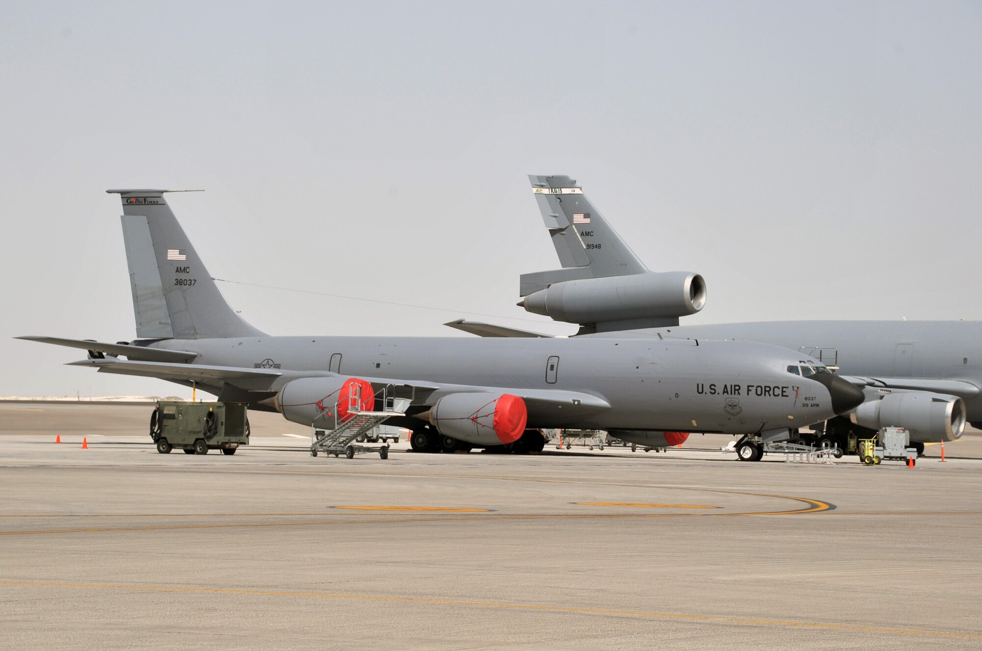 A KC-135R Stratotanker deployed from Grand Forks Air Force Base, N.D., and a KC-10 Extender deployed from Travis AFB, Calif., are parked on the flightline operations area for the 380th Air Expeditionary Wing at a non-disclosed base in Southwest Asia on June 2, 2010. Both airframes support deployed air refueling efforts through the 908th Expeditionary Air Refueling Squadron. The 908th EARS, as part of the 380th Air Expeditionary Wing, supports operations Iraqi Freedom, Enduring Freedom, and the Combined Joint Task Force-Horn of Africa. The 908th EARS is a sub-unit of the 380th Air Expeditionary Wing. (U.S. Air Force Photo/Master Sgt. Scott T. Sturkol/Released)