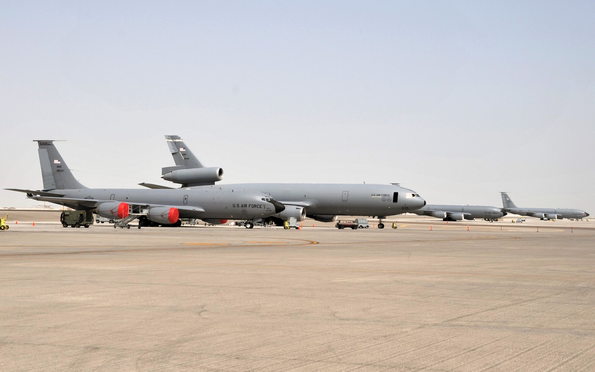 KC-135R Stratotankers and a KC-10 Extender are parked on the flightline operations area for the 380th Air Expeditionary Wing at a non-disclosed base in Southwest Asia on June 2, 2010. Both airframes support deployed air refueling efforts through the 908th Expeditionary Air Refueling Squadron. The 908th EARS, as part of the 380th Air Expeditionary Wing, supports operations Iraqi Freedom, Enduring Freedom, and the Combined Joint Task Force-Horn of Africa. The 908th EARS is a sub-unit of the 380th Air Expeditionary Wing. (U.S. Air Force Photo/Master Sgt. Scott T. Sturkol/Released)