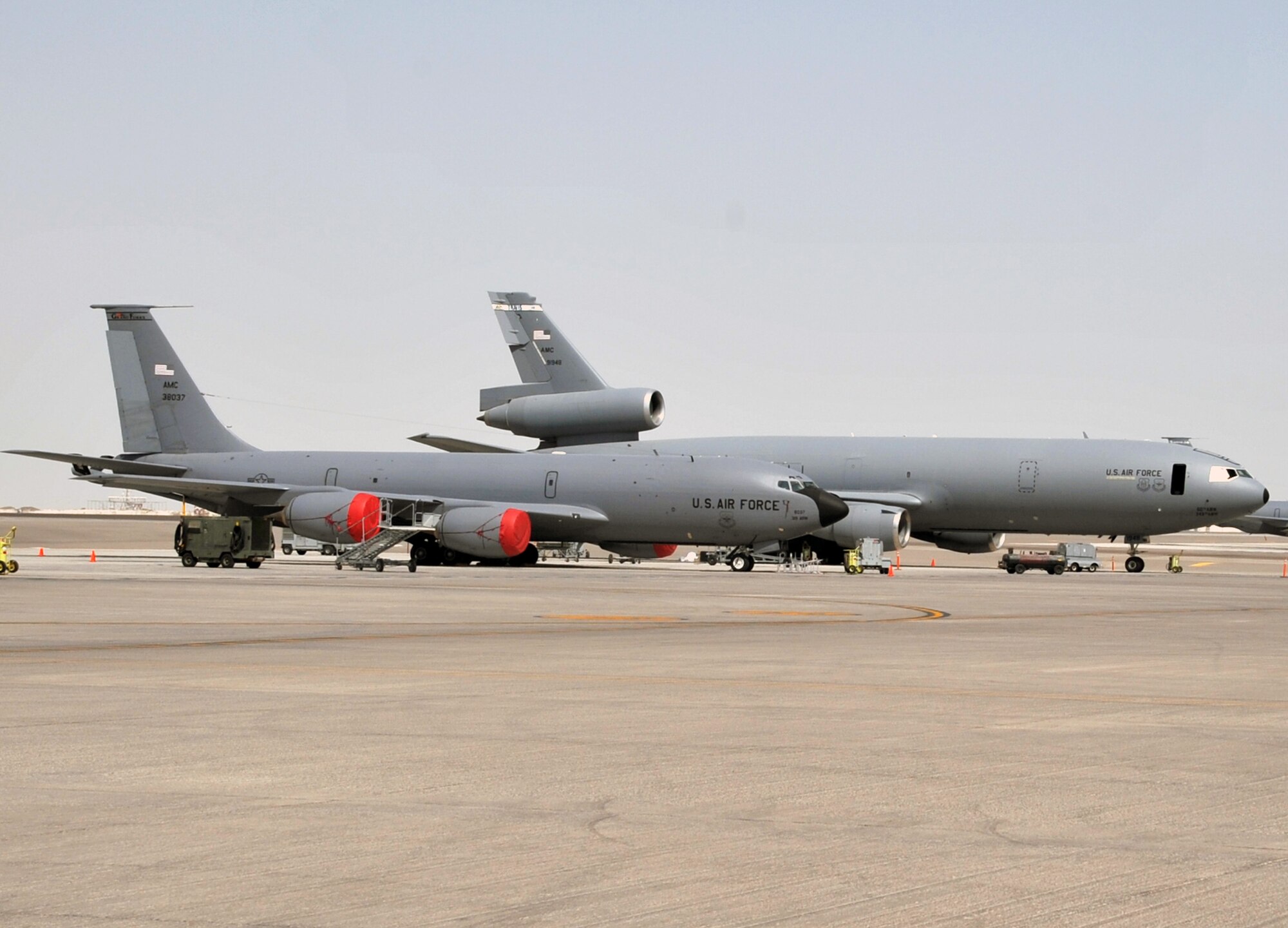 A KC-135R Stratotanker deployed from Grand Forks Air Force Base, N.D., and a KC-10 Extender deployed from Travis AFB, Calif., are parked on the flightline operations area for the 380th Air Expeditionary Wing at a non-disclosed base in Southwest Asia on June 2, 2010. Both airframes support deployed air refueling efforts through the 908th Expeditionary Air Refueling Squadron. The 908th EARS, as part of the 380th Air Expeditionary Wing, supports operations Iraqi Freedom, Enduring Freedom, and the Combined Joint Task Force-Horn of Africa. The 908th EARS is a sub-unit of the 380th Air Expeditionary Wing. (U.S. Air Force Photo/Master Sgt. Scott T. Sturkol/Released)