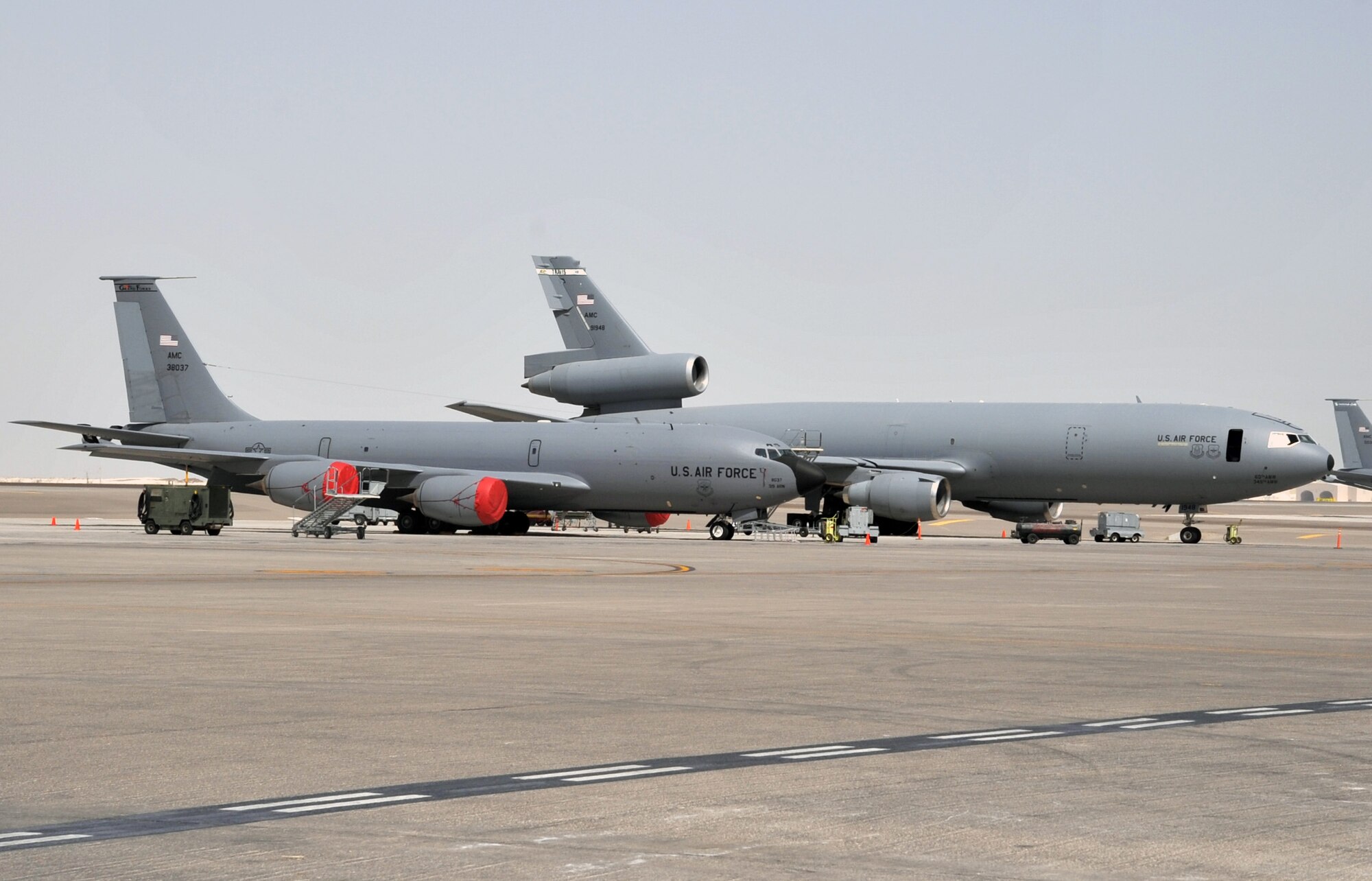 A KC-135R Stratotanker deployed from Grand Forks Air Force Base, N.D., and a KC-10 Extender deployed from Travis AFB, Calif., are parked on the flightline operations area for the 380th Air Expeditionary Wing at a non-disclosed base in Southwest Asia on June 2, 2010. Both airframes support deployed air refueling efforts through the 908th Expeditionary Air Refueling Squadron. The 908th EARS, as part of the 380th Air Expeditionary Wing, supports operations Iraqi Freedom, Enduring Freedom, and the Combined Joint Task Force-Horn of Africa. The 908th EARS is a sub-unit of the 380th Air Expeditionary Wing. (U.S. Air Force Photo/Master Sgt. Scott T. Sturkol/Released)