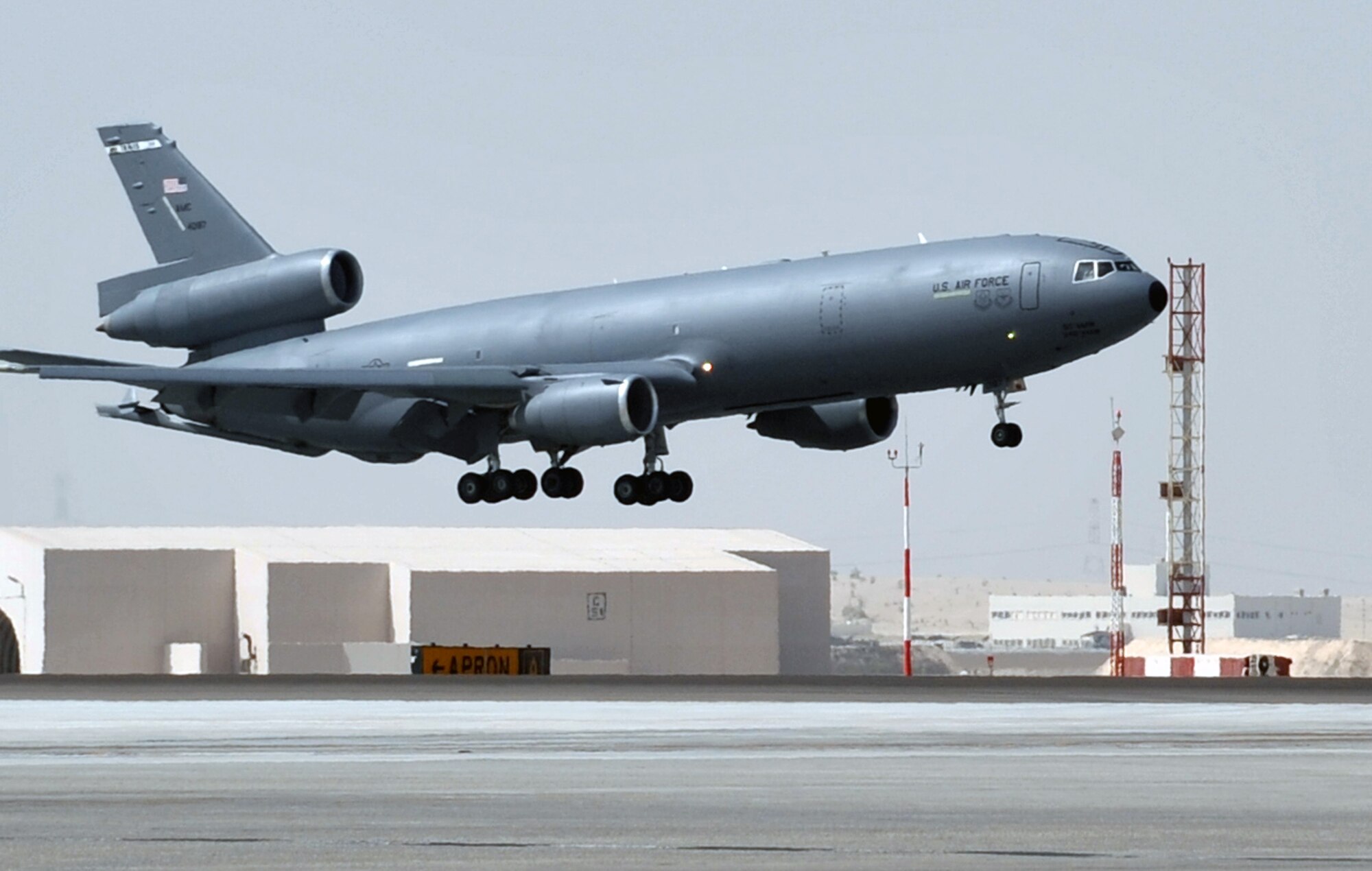 A flight crew from the 908th Expeditionary Air Refueling Squadron guides a KC-10 Extender, also from the 908th EARS, in for a landing at a non-disclosed base in Southwest Asia on June 2, 2010. According to statistics from Mr. Yancy Mailes, 380th AEW historian, KC-10s assigned to the 908th EARS and the Airmen who support and fly them flew more than 230 missions off-loading nearly 35 million pounds of fuel to more than 2,100 aircraft from January through April 2010. The 908th EARS, as part of the 380th Air Expeditionary Wing, supports operations Iraqi Freedom, Enduring Freedom, and the Combined Joint Task Force-Horn of Africa. The 908th EARS is a sub-unit of the 380th Air Expeditionary Wing. In addition to the KC-10 Extender, the 380th AEW is home to the U-2 Dragon Lady, E-3 Sentry and RQ-4 Global Hawk aircraft. The wing is comprised of four groups and 12 squadrons and the wing's deployed mission includes air refueling, surveillance and reconnaissance in support of overseas contingency operations in Southwest Asia. (U.S. Air Force Photo/Master Sgt. Scott T. Sturkol/Released)