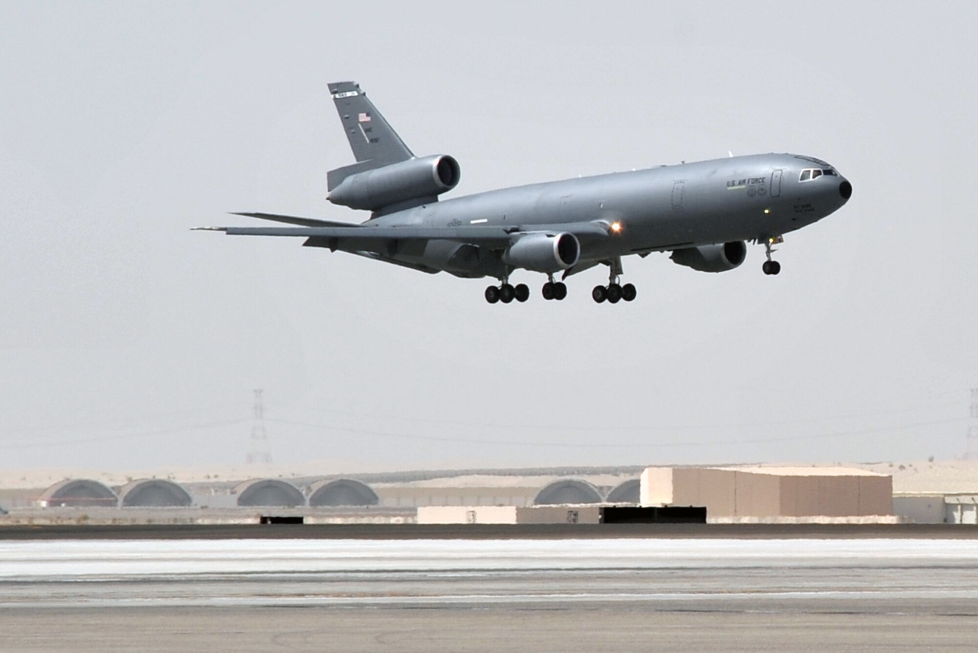 A flight crew from the 908th Expeditionary Air Refueling Squadron guides a KC-10 Extender, also from the 908th EARS, in for a landing at a non-disclosed base in Southwest Asia on June 2, 2010. According to statistics from Mr. Yancy Mailes, 380th AEW historian, KC-10s assigned to the 908th EARS and the Airmen who support and fly them flew more than 230 missions off-loading nearly 35 million pounds of fuel to more than 2,100 aircraft from January through April 2010. The 908th EARS, as part of the 380th Air Expeditionary Wing, supports operations Iraqi Freedom, Enduring Freedom, and the Combined Joint Task Force-Horn of Africa. The 908th EARS is a sub-unit of the 380th Air Expeditionary Wing. In addition to the KC-10 Extender, the 380th AEW is home to the U-2 Dragon Lady, E-3 Sentry and RQ-4 Global Hawk aircraft. The wing is comprised of four groups and 12 squadrons and the wing's deployed mission includes air refueling, surveillance and reconnaissance in support of overseas contingency operations in Southwest Asia. (U.S. Air Force Photo/Master Sgt. Scott T. Sturkol/Released)