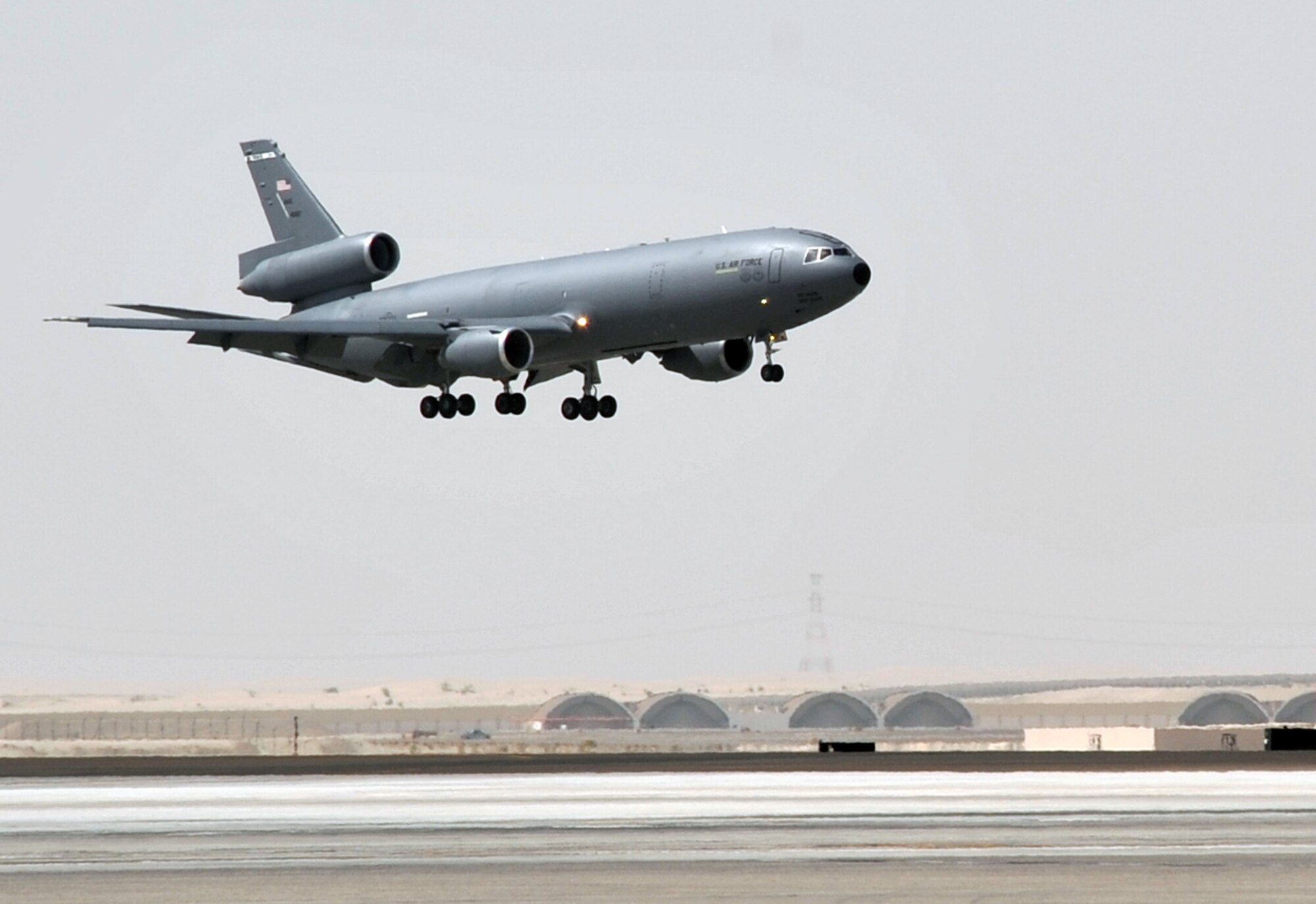 A flight crew from the 908th Expeditionary Air Refueling Squadron guides a KC-10 Extender, also from the 908th EARS, in for a landing at a non-disclosed base in Southwest Asia on June 2, 2010. According to statistics from Mr. Yancy Mailes, 380th AEW historian, KC-10s assigned to the 908th EARS and the Airmen who support and fly them flew more than 230 missions off-loading nearly 35 million pounds of fuel to more than 2,100 aircraft from January through April 2010. The 908th EARS, as part of the 380th Air Expeditionary Wing, supports operations Iraqi Freedom, Enduring Freedom, and the Combined Joint Task Force-Horn of Africa. The 908th EARS is a sub-unit of the 380th Air Expeditionary Wing. In addition to the KC-10 Extender, the 380th AEW is home to the U-2 Dragon Lady, E-3 Sentry and RQ-4 Global Hawk aircraft. The wing is comprised of four groups and 12 squadrons and the wing's deployed mission includes air refueling, surveillance and reconnaissance in support of overseas contingency operations in Southwest Asia. (U.S. Air Force Photo/Master Sgt. Scott T. Sturkol/Released)