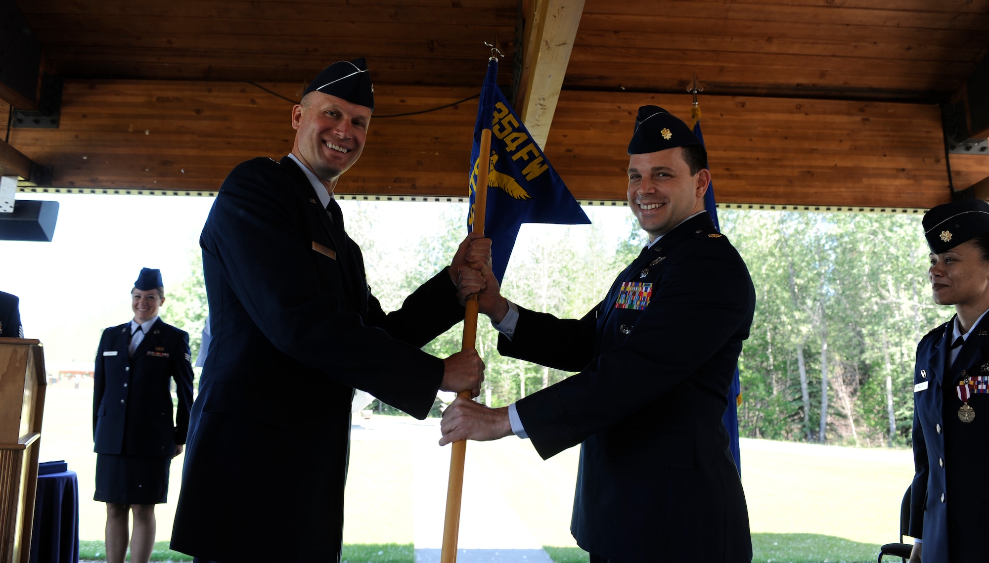 Brig. Gen. James N. Post III passes on the 354th Fighter Wing Comptroller guidon to Maj. Nicholas Bell June 14, 2010, Eielson Air Force Base, Alaska. This ceremonial gesture solidifies the major's new position as the comptroller squadron commander. General Post is the 354th Fighter Wing commander. (U.S. Air Force photo Airman 1st Class Willard E. Grande II)