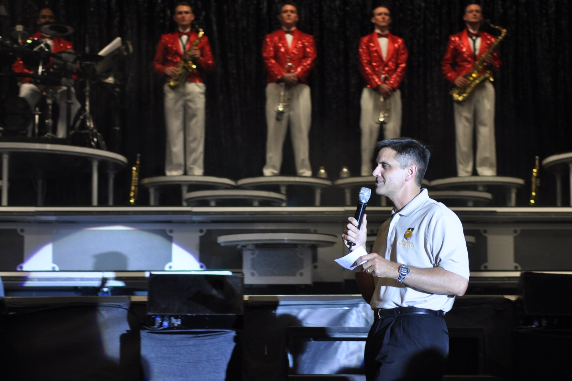 Col. Steven L. Basham, commander, 2nd Bomb Wing, kicks off the TOPS IN BLUE
concert in Hoban Hall at Barksdale Air Force Base, La., June 15, 2010.
Colonel Basham beamed as a proud father would as he gave a shout out to two
of the 2nd Bomb Wing's own Airmen, who returned to Barksdale as volcalists
performing on the stage for the crowd. Staff Sgt. Chonte Walker and Airman
First Class Megan Harvey are now on tour with the TOPS IN BLUE performers.
Sergeant Walker is an emergency management journeyman with the 2nd Civil
Engineering Squadron and Airman Harvey is an aircraft structural maintenance
journeyman with the 2nd maintenance Squadron. TOPS IN BLUE is one of the
oldest and most widely traveled entertainment groups of its kind. It has a
distinctive history, spanning 57 years. The 2010 tour, entitled "We
Believe," is a salute to the ideas we believe in as Americans. (U.S. Air
Force photo/Tech. Sgt. Jeff Walston)
