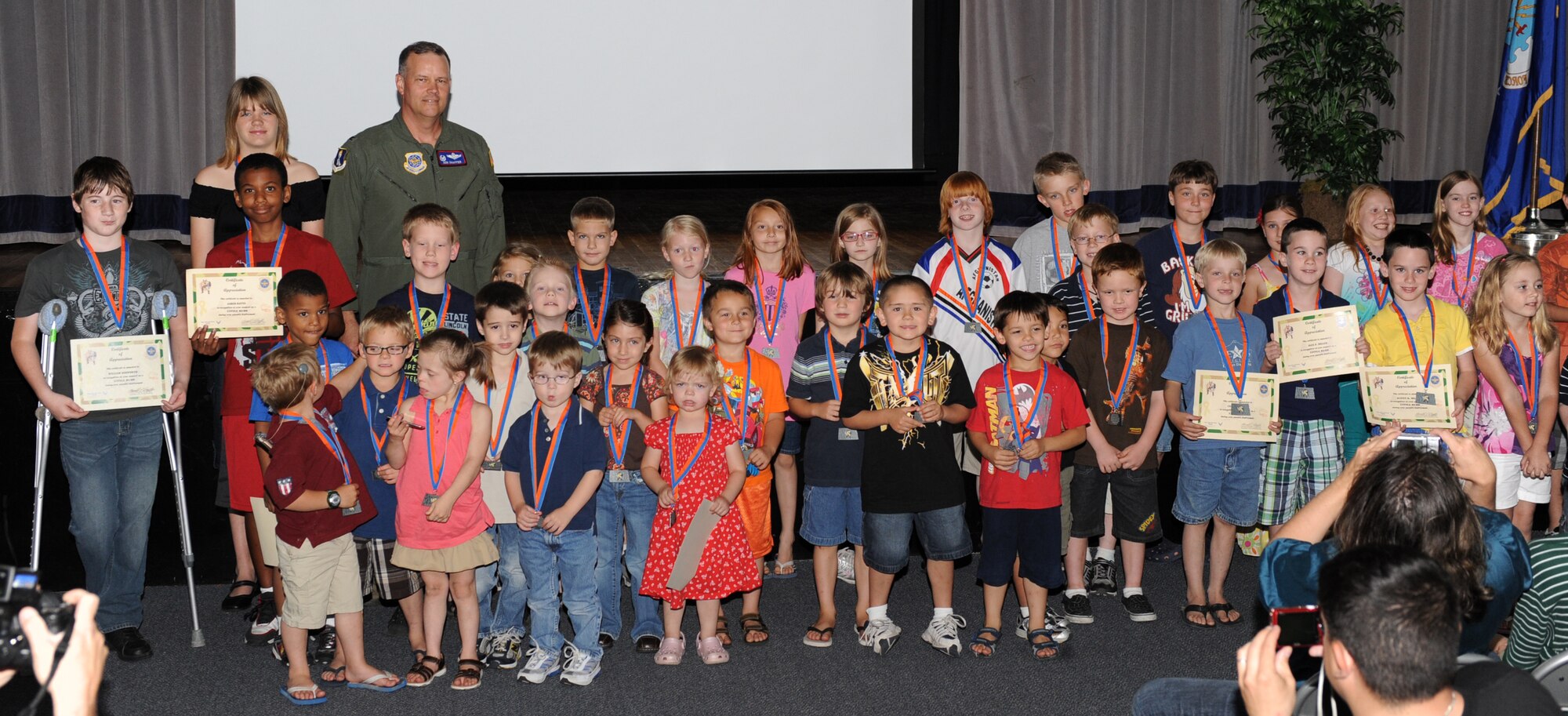 Col. Don Shaffer, 319th Air Refueling Wing commander, poses for a group photo with the Little Heroes award recipients at the Little Hero Ceremony, June 16 at the Community Activity Center.  The Little Hero award recognizes the support and service of the children of active-duty parents, and the recipients were nominated by their parents for their contributions to their success in the military. (U.S. Air Force photo by Airman 1st Class Amber Price)