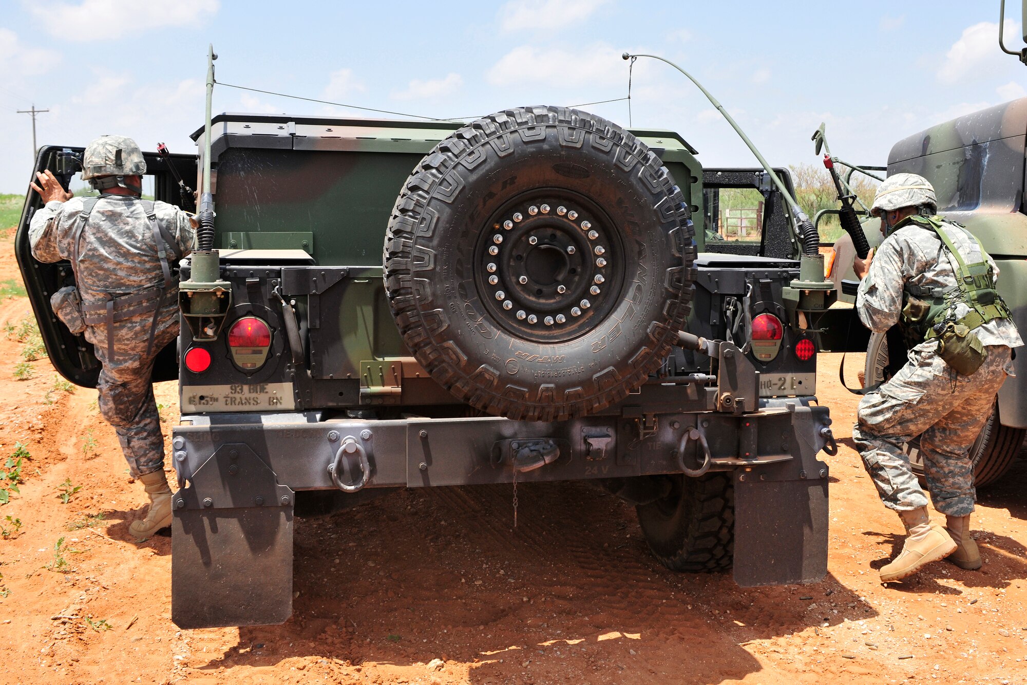 Soldiers of the New Mexico National Guard, 615th Transportation Battalion, jump into their humvee as they leave the area of a simulated ambush, June 15. The 615th Transportation Battalion, stayed at Cannon from June 11-17 to conduct training operations at Melrose Air Force Range. The time on the range included tactics training and procedures refreshers and theater specific scenarios. (US Air Force Photo by Technical Sgt. Josef Cole)
