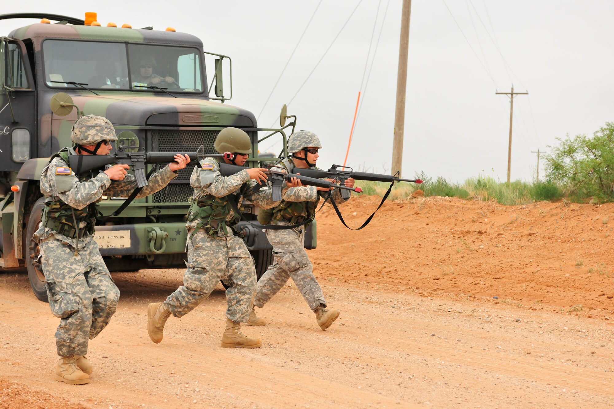 Soldiers of the New Mexico National Guard, 615th Transportation Battalion, purse a opposition forces member during a simulated convoy attack, June 15. The 615th Transportation Battalion, stayed at Cannon from June 11-17 to conduct training operations at Melrose Air Force Range. The time on the range included tactics training and procedures refreshers and theater specific scenarios. (US Air Force Photo by Technical Sgt. Josef Cole)