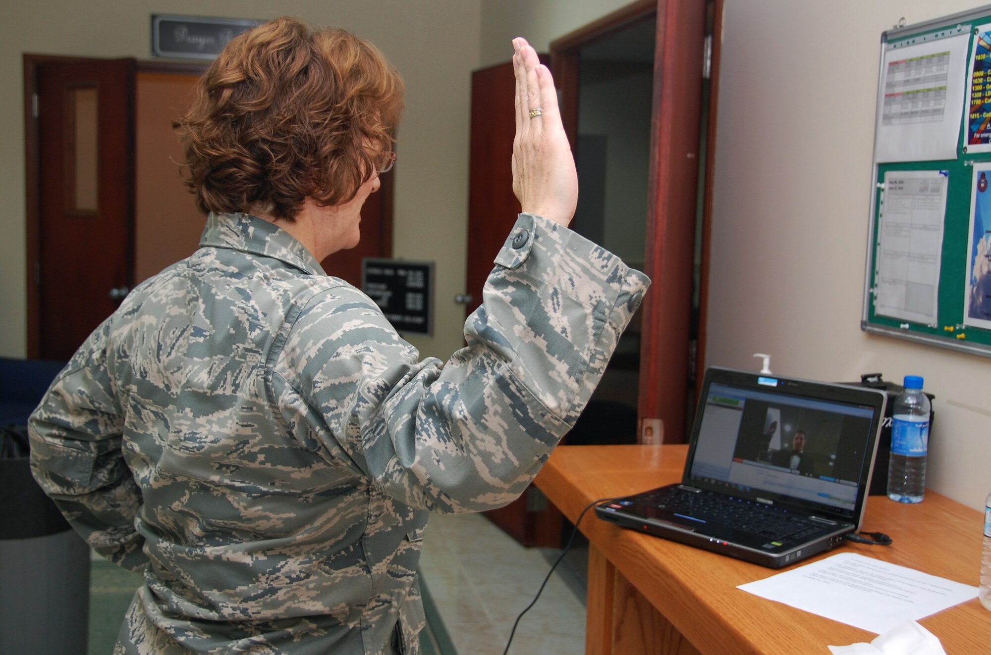 U.S. Air Force Lt. Col. Maureen Carroll swears her son, now-2nd Lt. Alek Krallman, into the Air Force June 13, 2010, in Southwest Asia, via the Internet during his Air Force ROTC graduation from Central Washington University in Ellensburg, Wash. Colonel Carroll is the 386th Expeditionary Maintenance Squadron commander. (U.S. Air Force photo/Tech. Sgt. Lindsey Maurice) 