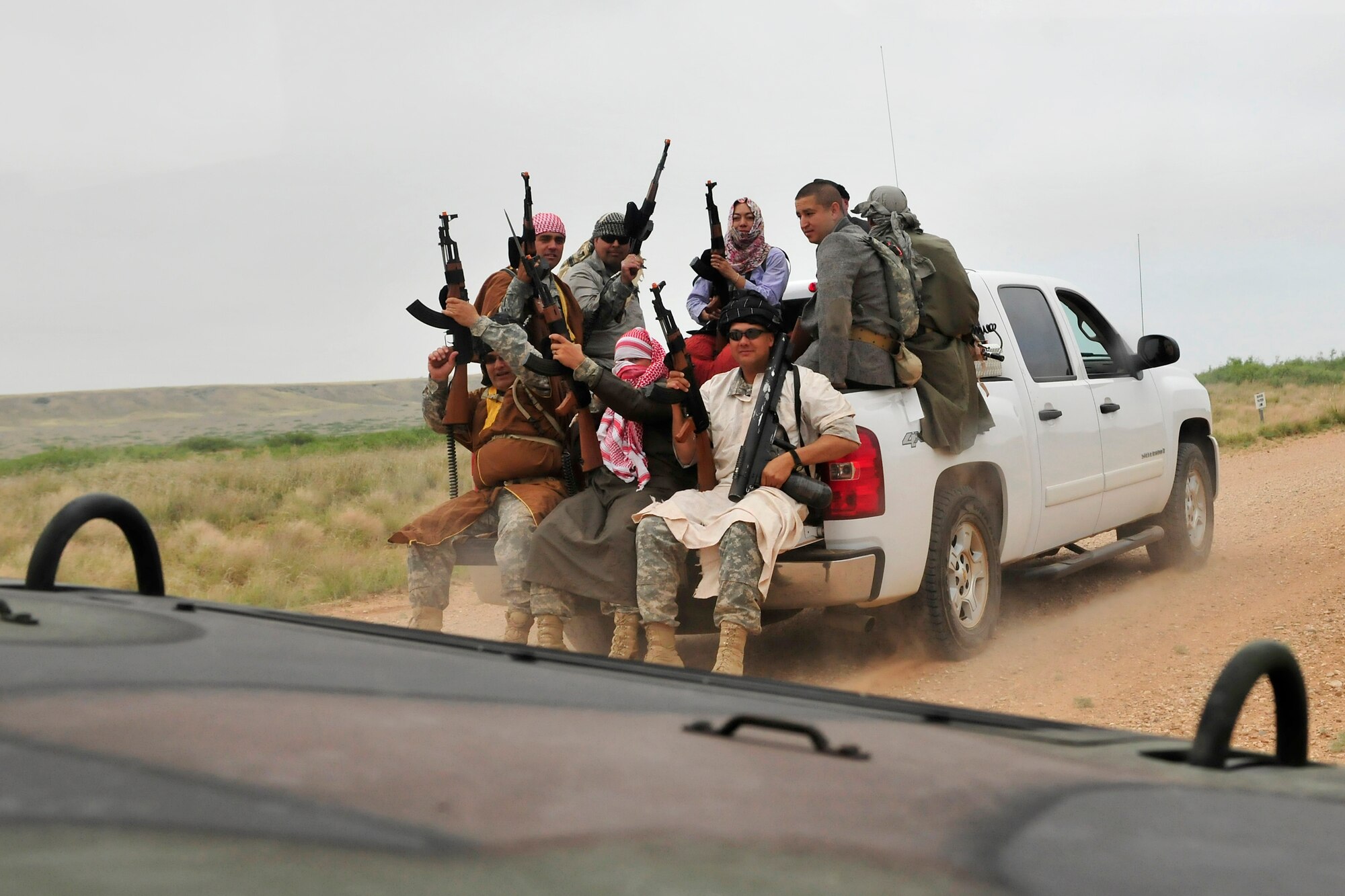 Soldiers of the New Mexico National Guard, 615th Transportation Battalion, ride to a training area dressed as opposition forces, June 15. The 615th Transportation Battalion, stayed at Cannon from June 11-17 to conduct training operations at Melrose Air Force Range. The time on the range included tactics training and procedures refreshers and theater specific scenarios. (US Air Force Photo by Technical Sgt. Josef Cole)