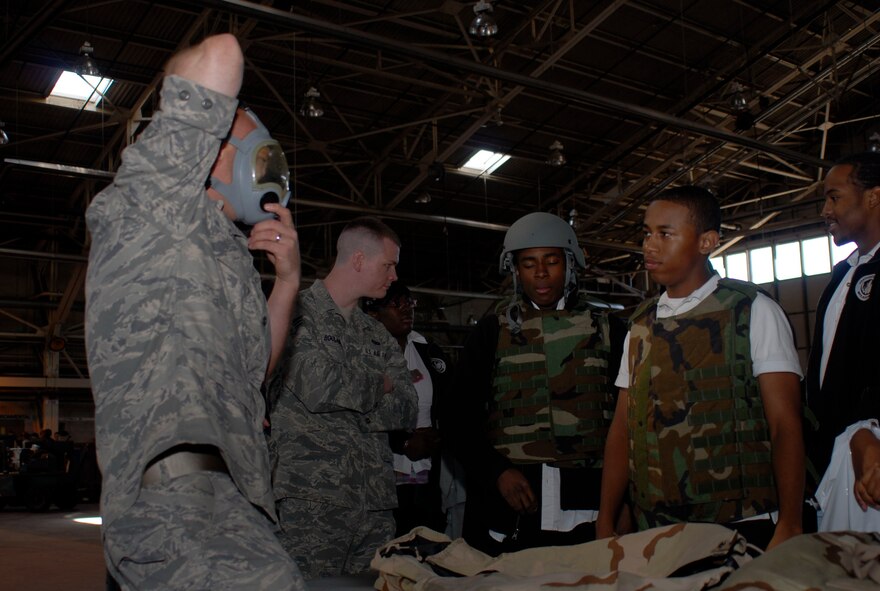 Tech. Sgt. Jeff Collins, base supply, 103 Logistics Readiness Squadronm, gets into character to show high school students from Weaver High School, Hartford, Conn. how to properly don the MCU-2/P gas mask, May 13, 2010, in the hangar at Bradley Air National Guard Base, East Granby, Conn. during Career Day, a two-day event that shows high school students how the education they are getting now can transfer to jobs after school. (U.S. Air Force photo by Tech. Sgt. Joshua Mead)