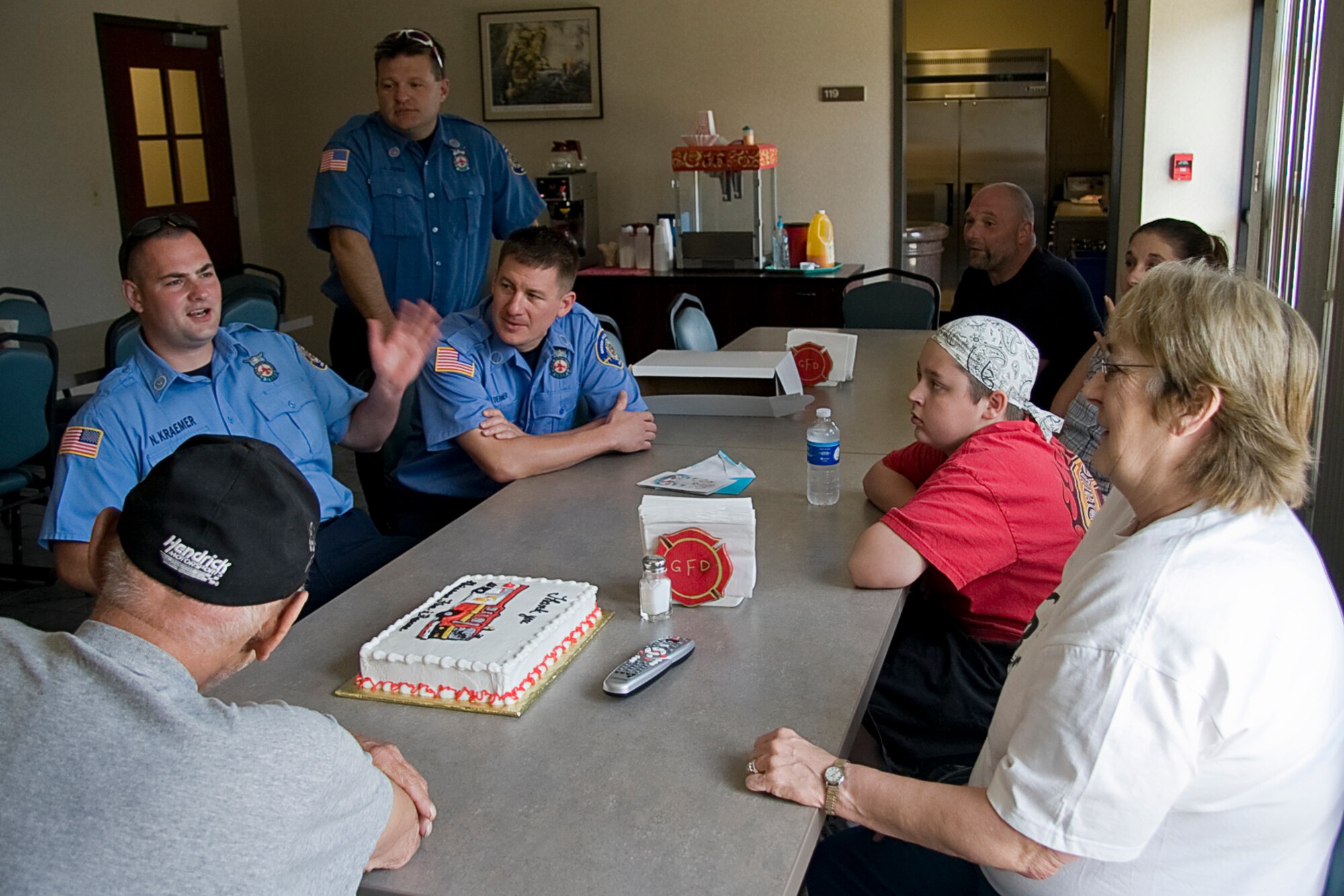 GRISSOM AIR RESERVE BASE, Ind. -- Nathan Kraemer, a Grissom firefighter, describes the scene he and Rescue 5's other crewmembers encountered recently when called off base to save the life of Rita Lawrence. Mrs. Lawrence and her family recently visited Grissom to thank the firefighters for a job well done, sharing memories, laughter and praise. (U.S. Air Force photo/Tech. Sgt. Mark R. W. Orders-Woempner)