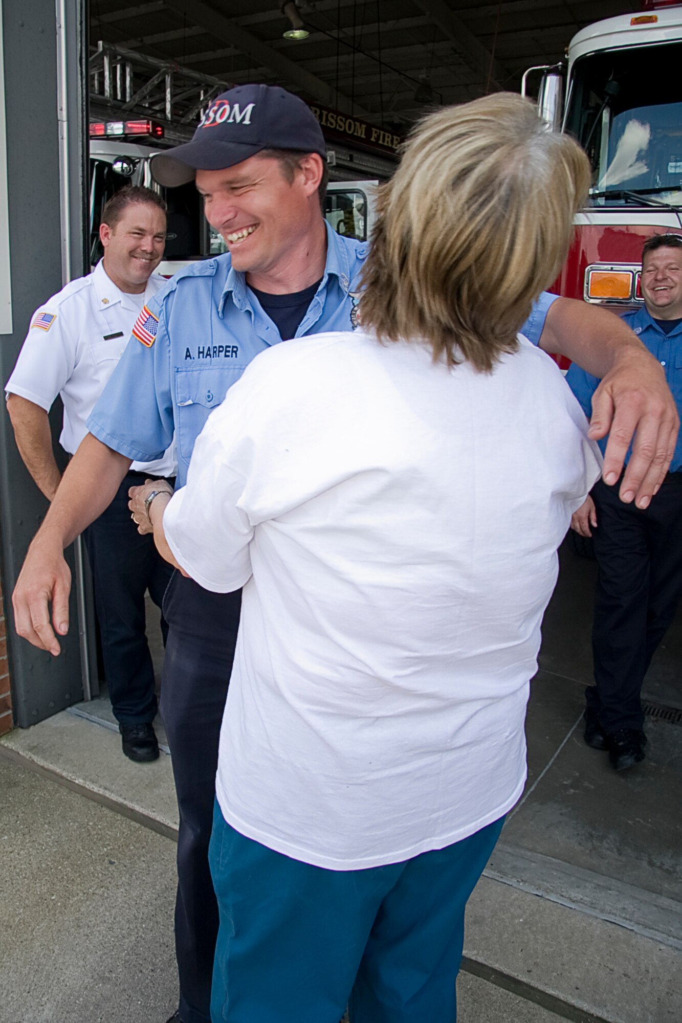 GRISSOM AIR RESERVE BASE, Ind. -- Anthony Harper gets a big hug from Rita Lawrence as she visited the Grissom Fire Department recently to thank Mr. Harper and the rest of Rescue 5's crew who saved her life. Grissom's emergency responders often go off base, providing life-saving services to the local community. Without Grissom's quick response, Mrs. Lawrence said she'd have been "pushing up daisies."  (U.S. Air Force photo/Tech. Sgt. Mark R. W. Orders-Woempner)