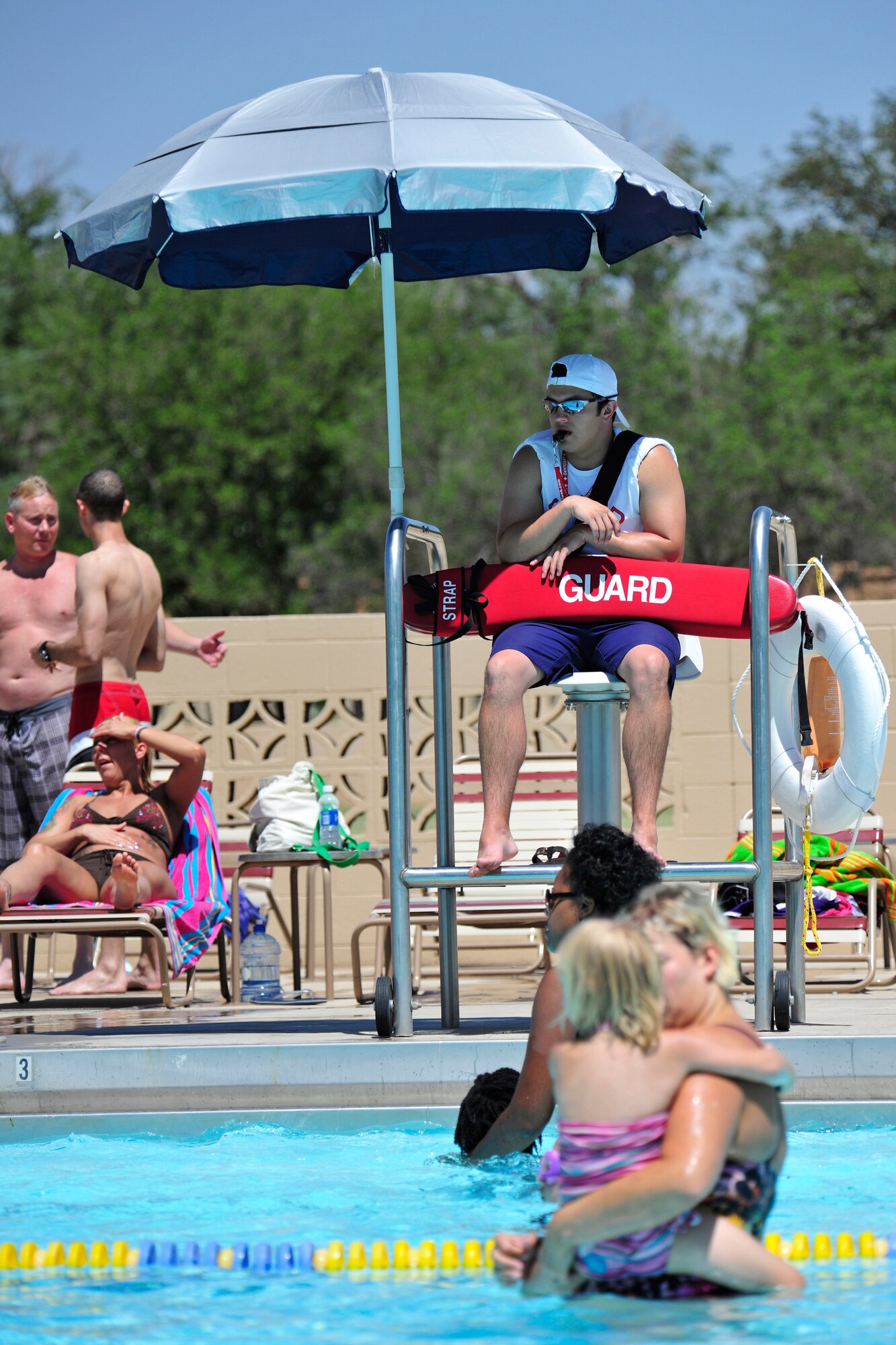 Brad Props, a life guard at the Drop Zone, ensures swimmer's have a safe envirnoment for swimming during the grand opening of the base pool, June 12. (US Air Force Photo by Technical Sgt. Josef Cole) 