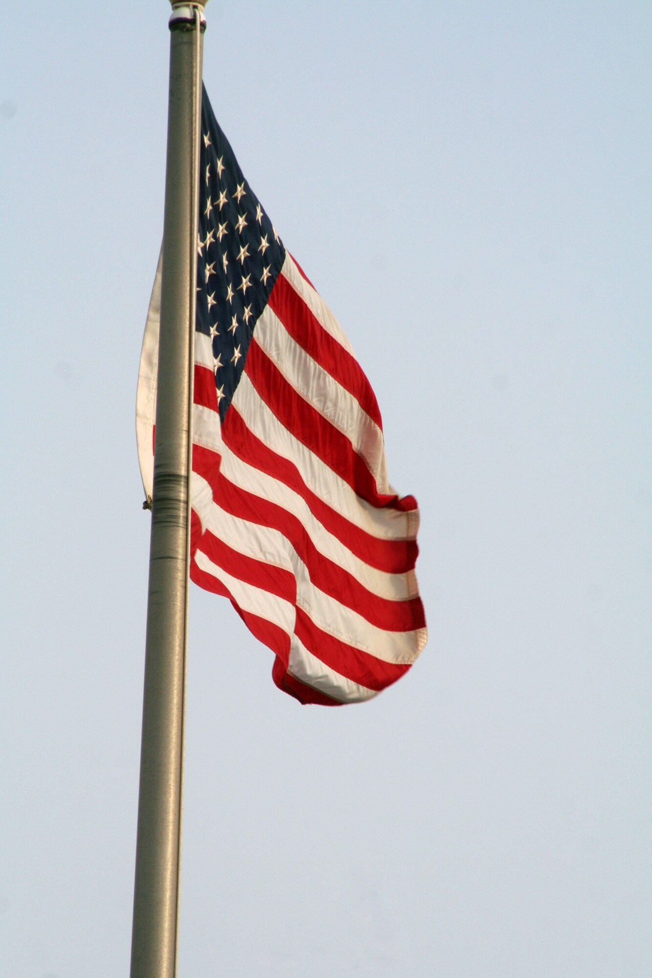 The American flag flies on the wing flagpole as Airmen from the 380th Air Expeditionary Wing participate in a wing-wide retreat ceremony at a non-disclosed base in Southwest Asia on June 11, 2010. Every week the 380th AEW holds a retreat ceremony to honor the American flag and as part of a military tradition. During the June 11 ceremony, the 380th Expeditionary Operations Group served as the lead unit in formation. The 380th AEW supports operations Iraqi Freedom and Enduring Freedom and the Combined Joint Task Force-Horn of Africa. (U.S. Air Force Photo/Master Sgt. Scott T. Sturkol/Released)
