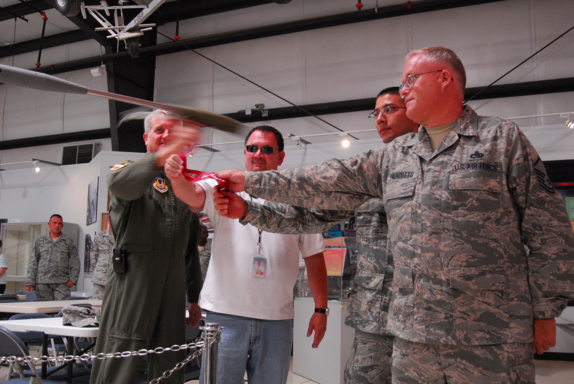 Left to right, Gen. David Eichhorn, Air Force Flight Test Center commander, Mr. Al Hoffman, 417th Flight Test Squadron program manager, Master Sgt. Eric West, 412th Aircraft Maintenance Squadron production superintendant and Master Sgt. Gary Palazotto, 31st Test and Evaluation Squadron weapons flight chief, remove the red flag shroud from the pitot tube June 11 to dedicate the YF-22 Raptor prototype’s return to Edwards and the Air Force Flight Test Center Museum.  (Official U.S. Air Force photograph by Stephen K. Robinson)