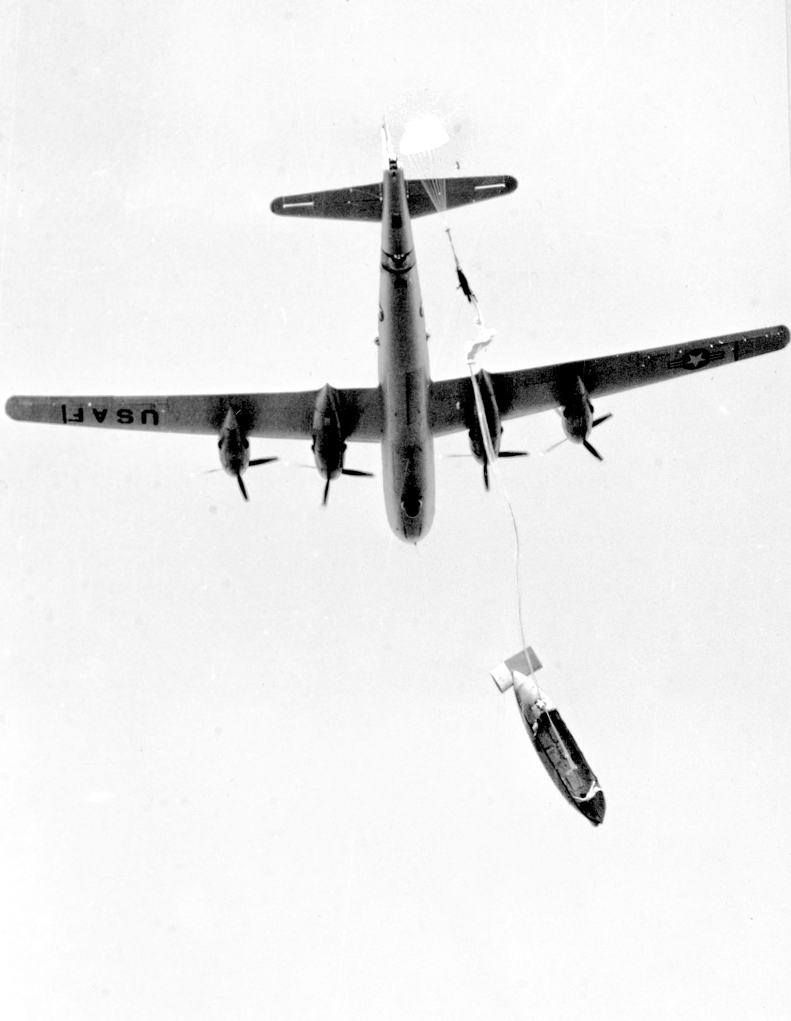 As the lifeboat falls away, a small drogue parachute opens the main parachute. (U.S. Air Force)