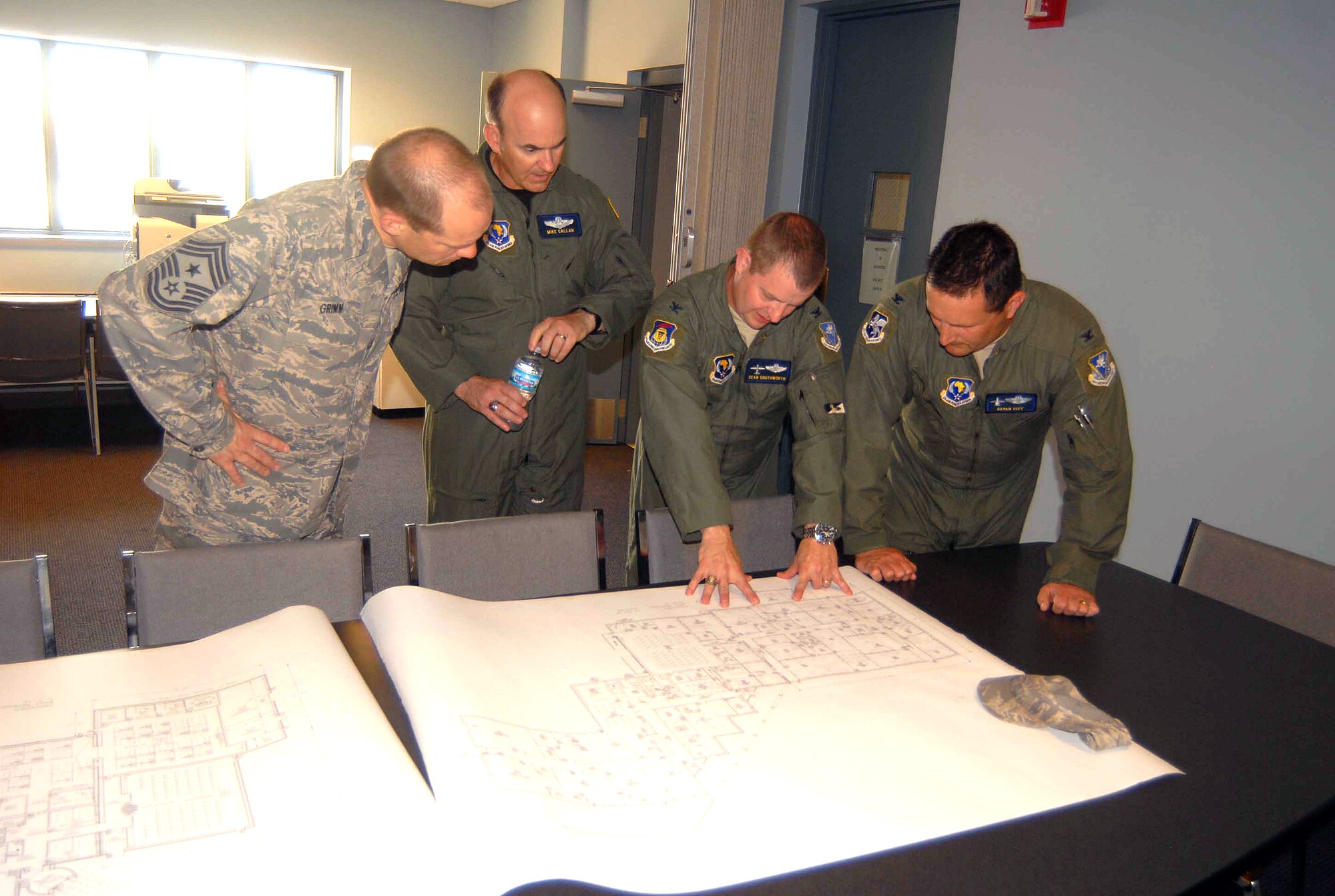 BATTLE CREEK, Mich.—(Left to right) Seventeenth Air Force (Air Forces Africa) Command Chief Master Sergeant Mike Grimm and Vice Commander Brig. Gen. Mike Callan, view blueprints for new facilities with 110th Air Mobility Squadron Commander Lt. Col. Sean Southworth and 110th Air Operations Squadron Commander Col. Bryan Teff June 3.  The visitors spent time with the Michigan Air National Guard’s 110 AOG, which has a supporting relationship to the AFAFRICA June 3-6. (U.S. Air Force Photo by Tech. Sgt. Alec Lloyd)