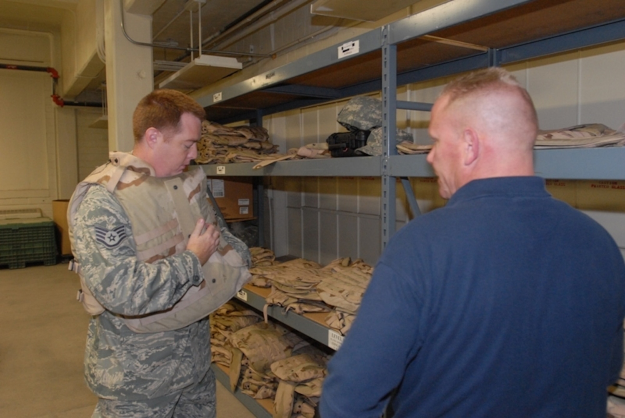 Staff Sgt. Chad Manson,  17th Contracting Squadron, tries on body armor at the Vance Deployment Center while David Swanson, 17th Logistics Readiness Squadron, stands by to assist him with getting the proper size June 15. (U.S. Air Force photo/Master Sgt. Randy Mallard)