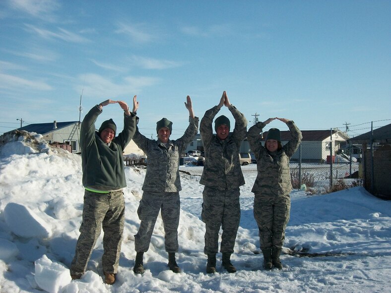 WRIGHT-PATTERSON AIR FORCE BASE, Ohio – From left to right: Tech. Sgt. Anna Tracy, 445th Logistics Readiness Squadron, Tech. Sgt. Kelly Kruger, 445th Services Flight, Maj. Michael Vollmer, 445th Logistics Readiness Squadron, and  Lt. Col. Jennifer Wedel, 445th Aeromedical Staging Squadron, spell out Ohio during some down time while deployed to Alaska for Operation Arctic Care, held April 9-23. Eight reservists from the 445th Airlift Wing had the opportunity to help Alaskan natives in need of humanitarian medical, dental, optometry and veterinary care during the operation. (Courtesy photo)