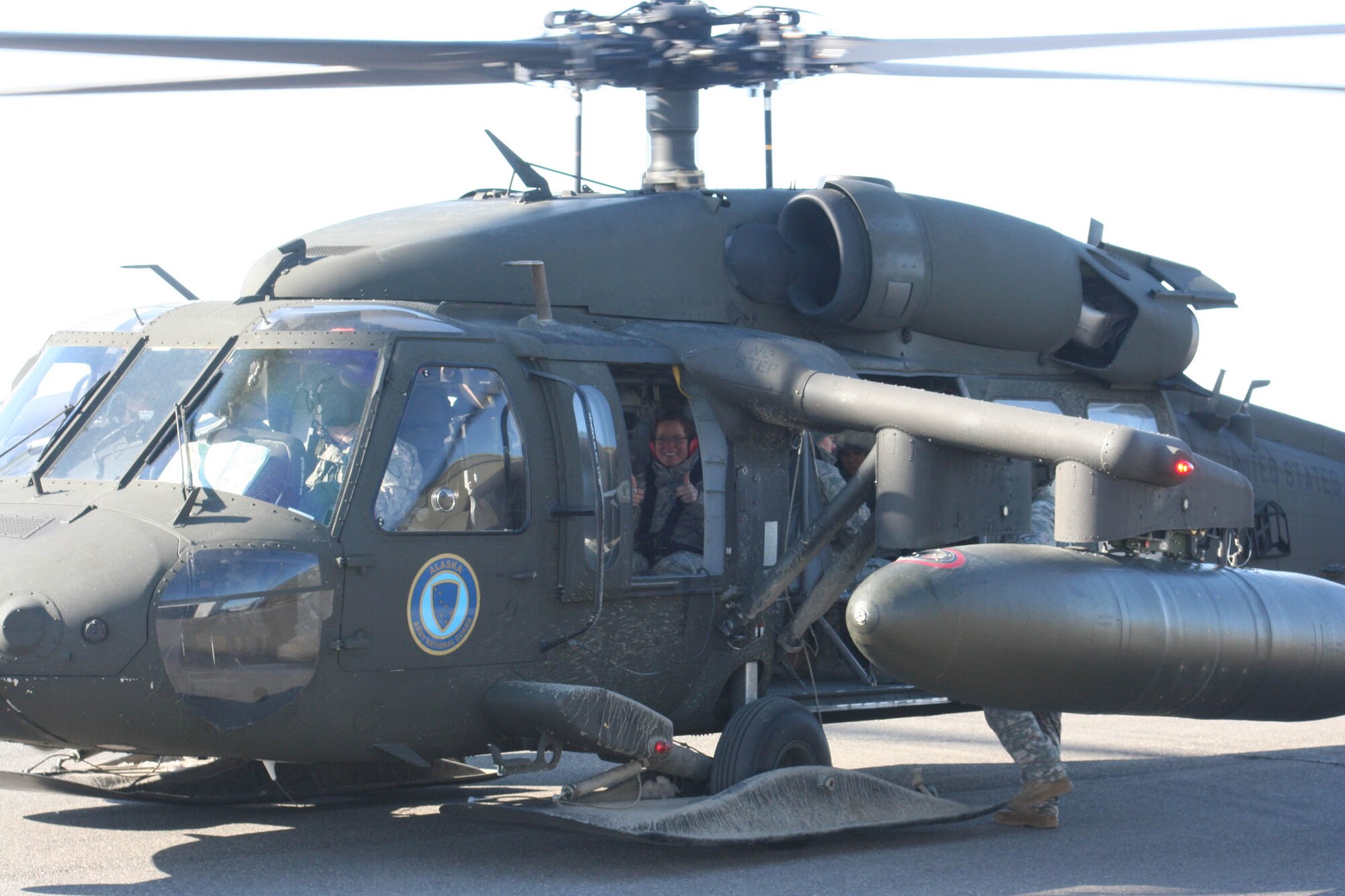 WRIGHT-PATTERSON AIR FORCE BASE, Ohio – Tech. Sgt. Anna Tracy, 445th Logistics Readiness Squadron, gives a thumbs-up as an Alaska Army National Guard Black Hawk helicopter takes off with military members participating in the 2010 Operation Arctic Care April 9-23. Eight reservists from the 445th Airlift Wing had the opportunity to help Alaskan natives in need of humanitarian medical, dental, optometry and veterinary care during the operation. (Courtesy photo)