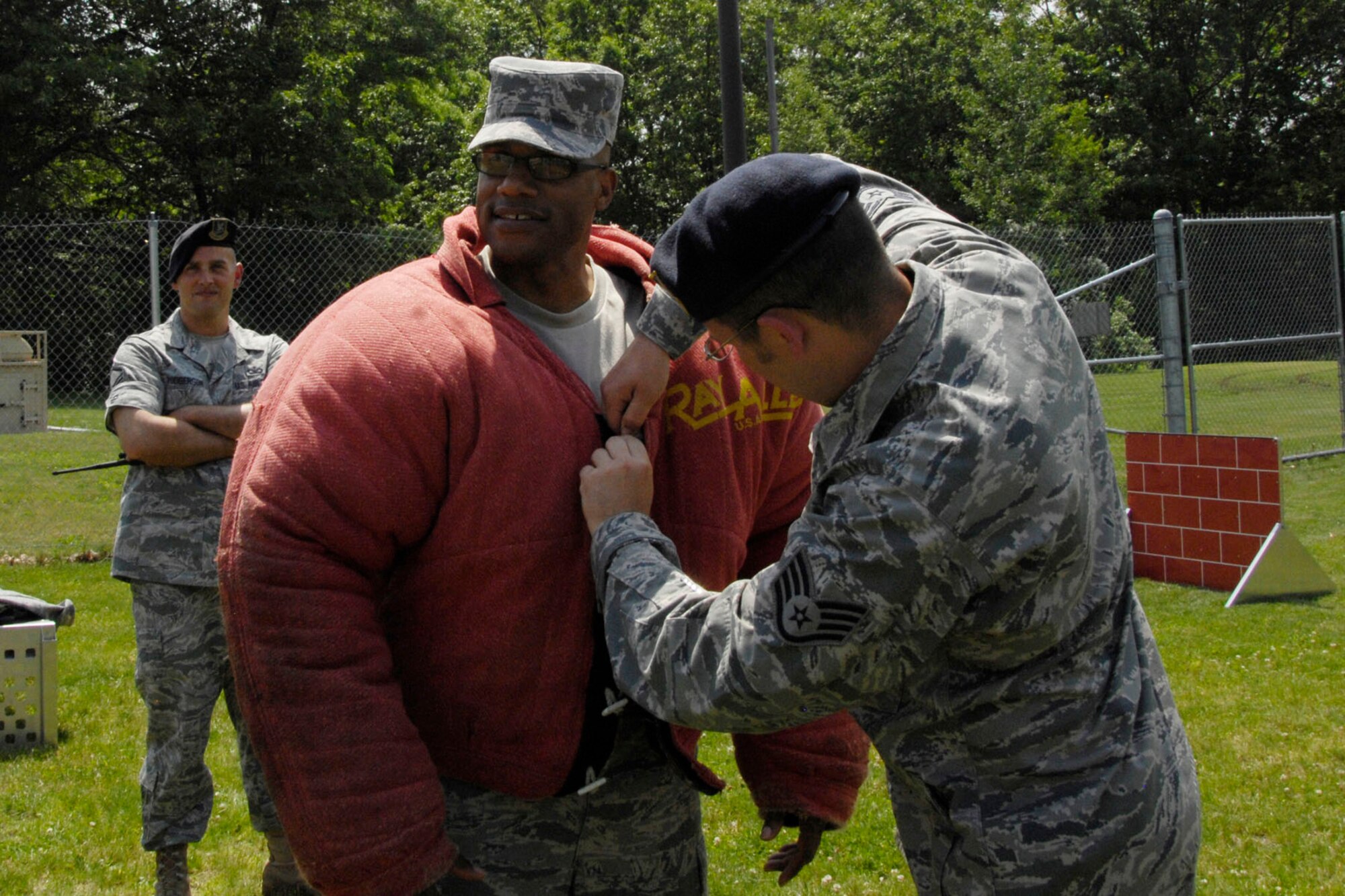 HANSCOM AIR FORCE BASE, Mass. – Staff Sgt. Richard Crotty secures the bite suit jacket on Chief Master Sgt. Kenneth A. Williams, Command Chief Master Sergeant for the Electronic Systems Center. Chief Williams recently visited the military working dogs and their trainers to learn more about what they do here and throughout New England. (U.S. Air Force photo by Linda LaBonte Britt)
