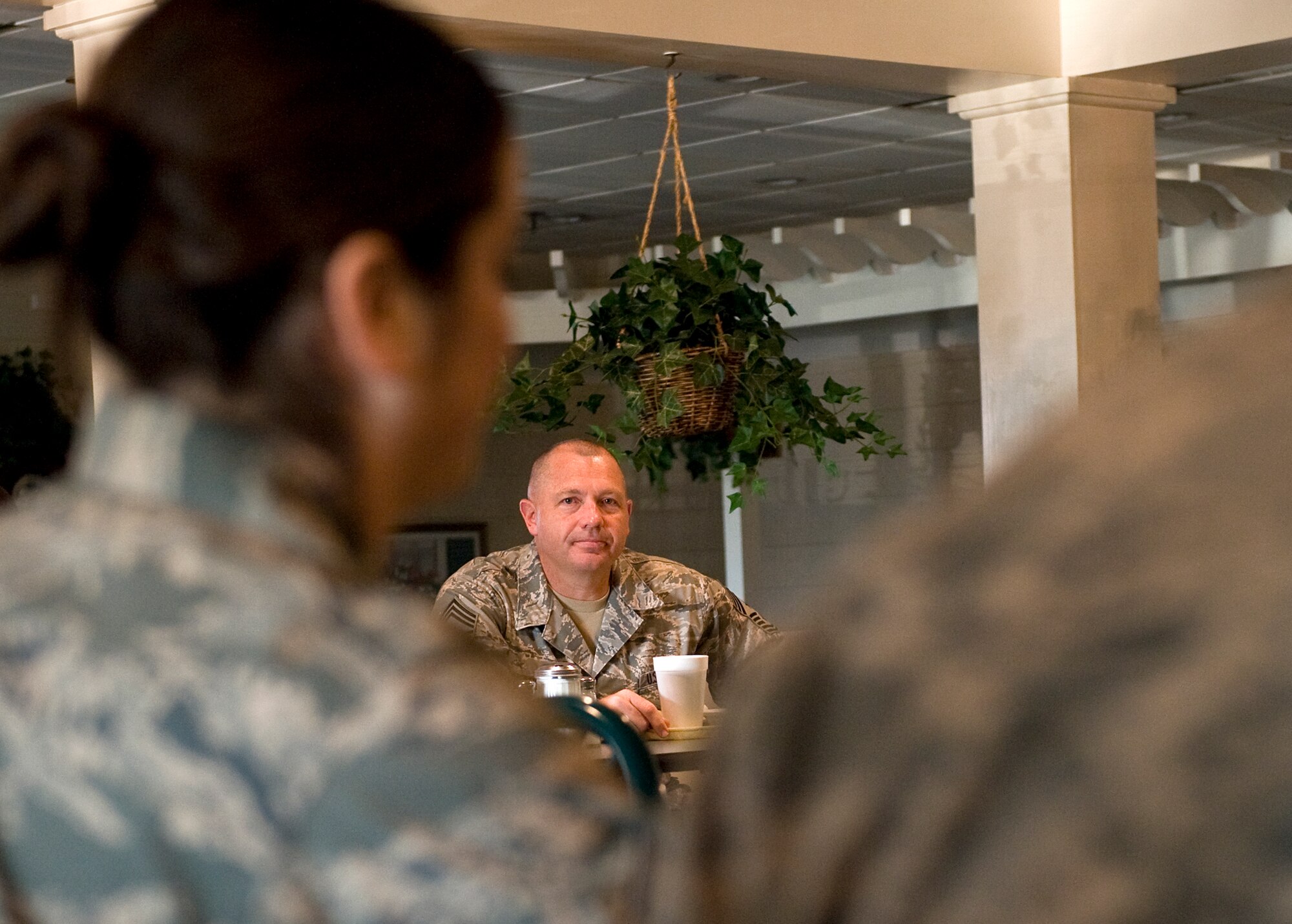 LANGLEY AIR FORCE BASE, Va. -- Chief Master Sgt. Scott Dearduff, 9th Air Force command chief, listens to a question posed by an Airman June 17.  Dearduff took time to eat with Airmen and address any concerns they might have.  (U.S. Air Force photo/Senior Airman Zachary Wolf)