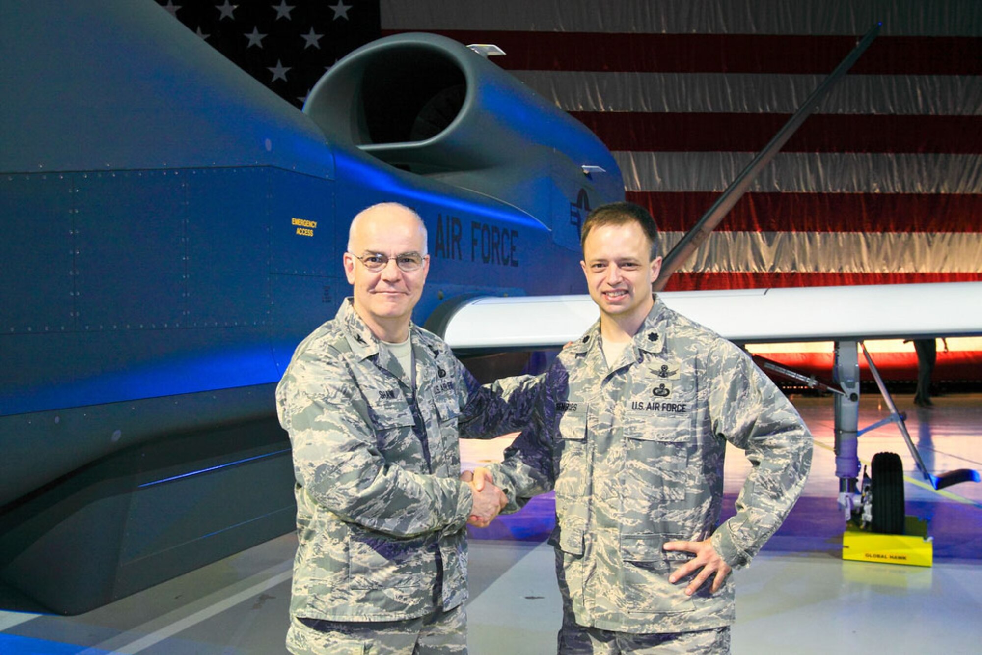 Col. James W. Shaw (left), 851st Electronic Systems Group commander, celebrates with Lt. Col. Chris Eisenbies, 638th Electronic Systems Squadron commander, after the Global Hawk Block 40 rollout in Palmdale, Calif., June 2009. Colonel Shaw is preparing to retire from the Air Force after more than 28 years of service. A retirement ceremony will be held June 25 at 10 a.m. at the Old North Bridge in Concord, Mass.  (Courtesy photo)