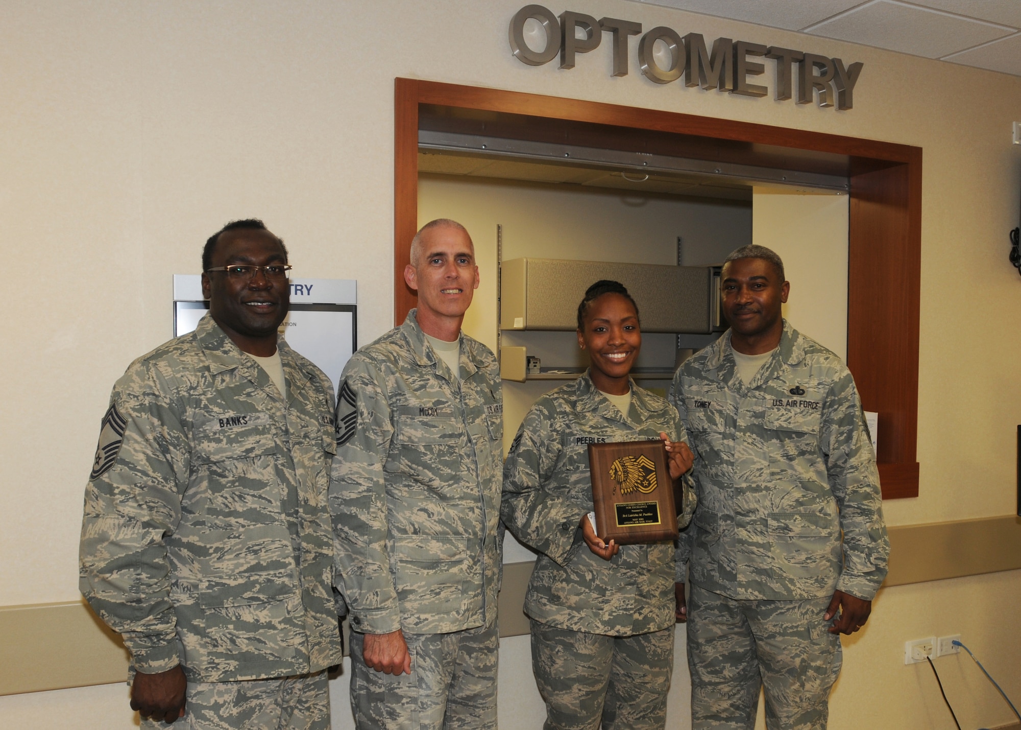 Senior Airman Latrisha Peebles, 31st Aerospace Medicine Squadron, is presented the Aviano Chief's Choice Award by the Aviano's Chief's group June 17, 2010. Aviano Chiefs present the Chief's Choice Award monthly to an Airman who clearly exceeds Air Force Standards in the areas of dress and appearance, bearing, and exceptional behavior in performance of their duties and in relationships with others.  (U.S. Air Force photo/Senior Airman Tabitha M. Mans)