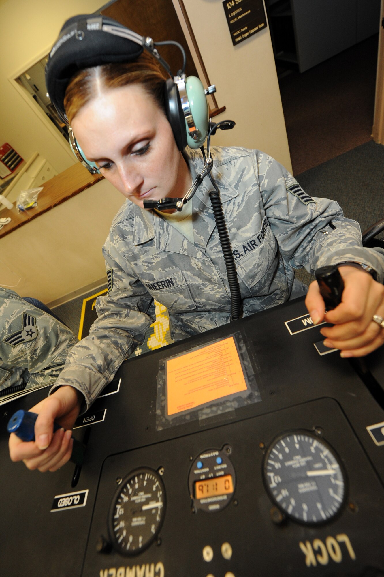 Tech. Sgt. Tasha Sherrin, 19th Medical Group NCO-in-charge of operations and support, increased and decreased altitude pressures from the chamber operator position during a chamber flight June 11. The chamber operator is in charge of the ascent and the decent of the chamber during a chamber flight. (U.S. Air Force photo by Senior Airman Ethan Morgan)