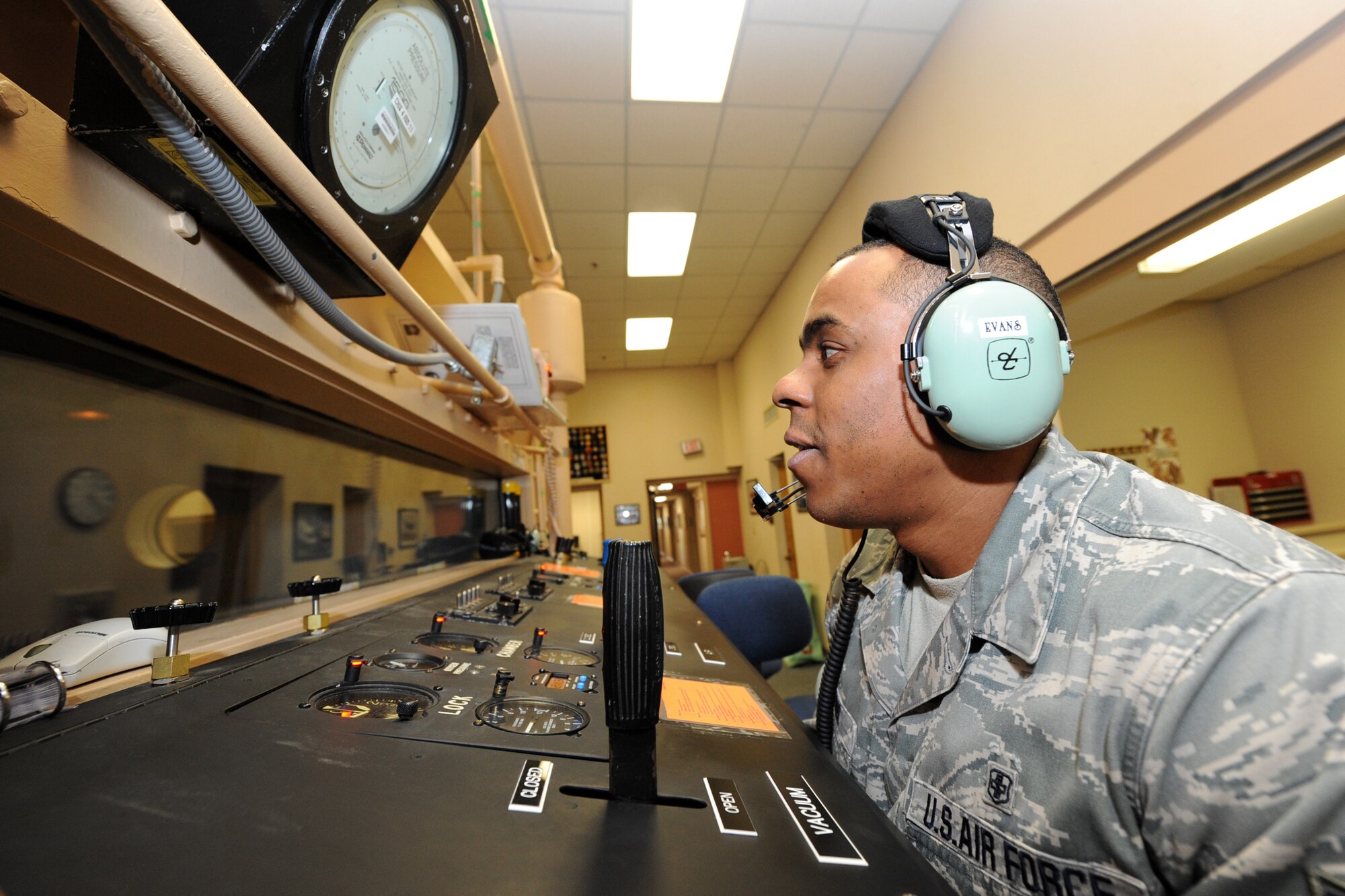 Senior Airman Brian Evans, a 19th Medical Group high altitude airdrop mission support technician, gives an Airman a block instruction course June 11 during a chamber flight. The initial course is two days long, which includes academic classes, type four chamber flight and a rapid decompression exercise while the refresher course is one-day long to include five hours of academics and a type four chamber flight. (U.S. Air Force photo by Senior Airman Ethan Morgan)
