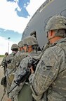 MINOT AIR FORCE BASE, N.D. – Airmen from the 5th Security Forces Squadron prepare to board a C-17 Globemaster III from McChord AFB, Wash., for weapons familiarization training here June 8.   The C-17 provides the Airmen with the opportunity enhance their skills on unfamiliar airframes. (U.S. Air Force photo by Staff Sgt. Miguel Lara III)