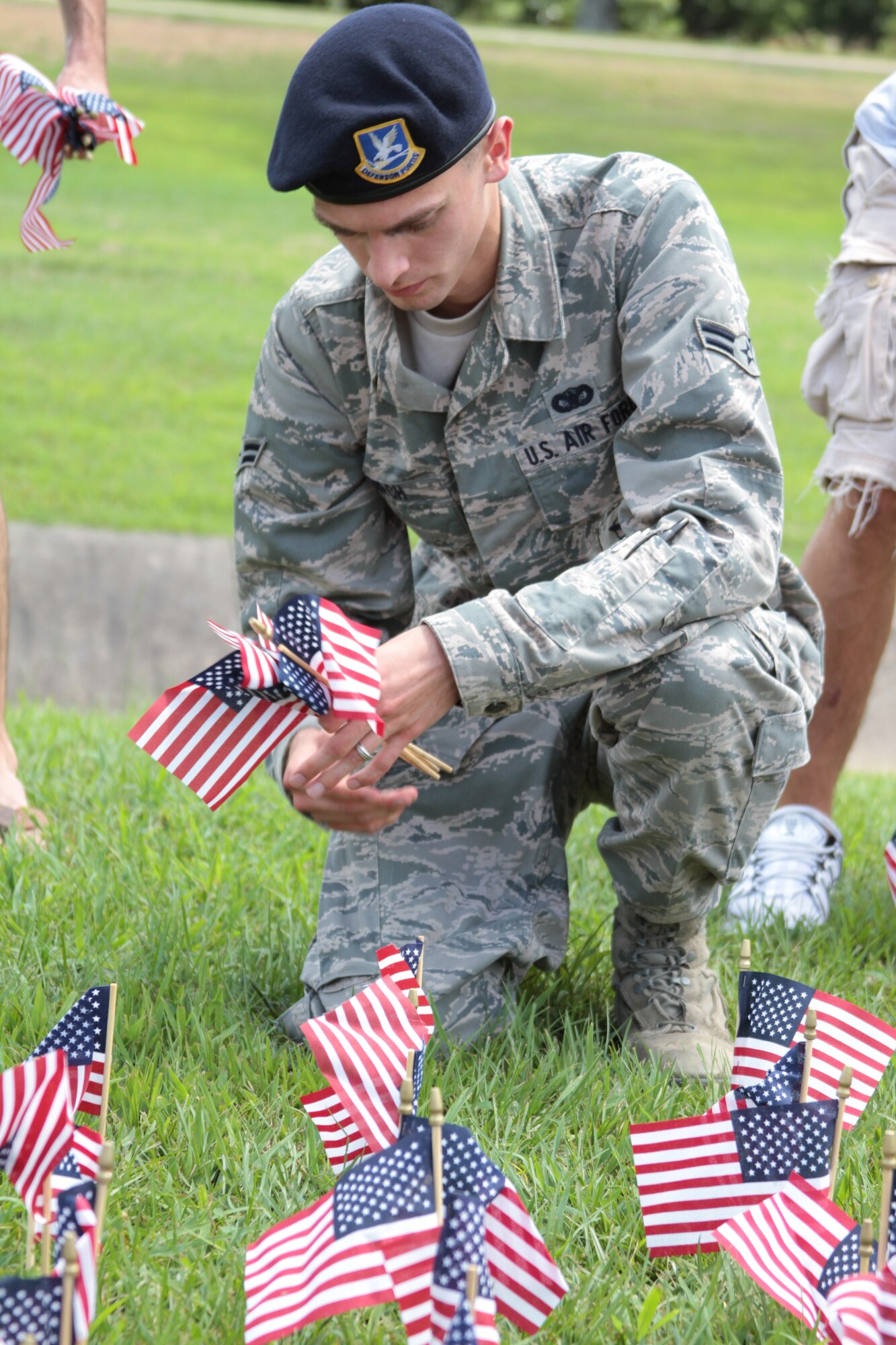Airman 1st Class Christopher Birch, 19th Security Forces Squadron security response team member, sets up flags June 13 at Heritage Park. The first official U.S. flag had 13 stars and 13 stripes. (U.S. Army photo by Spc. Jared Sollars)