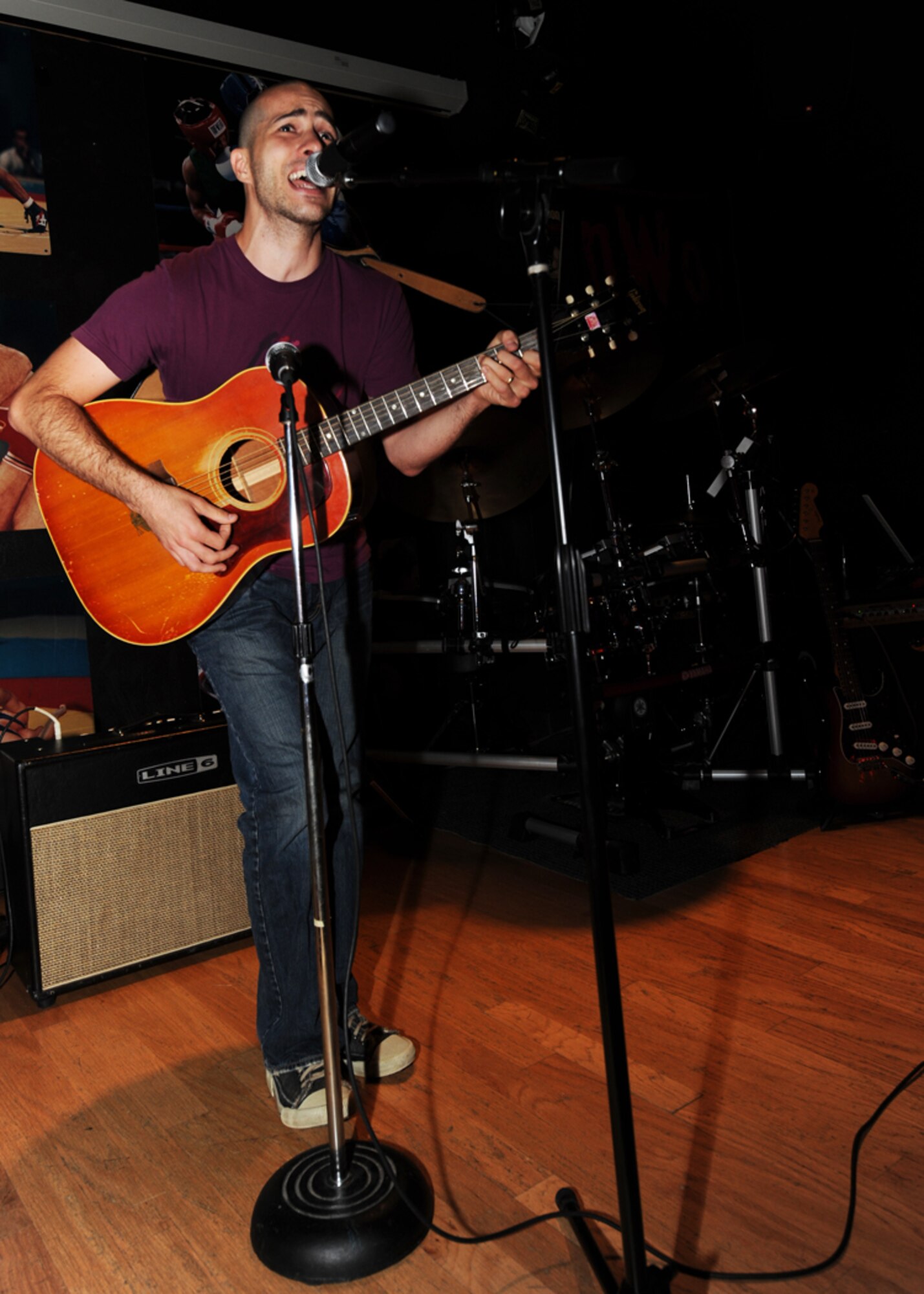 MINOT AIR FORCE BASE, N.D. -- Staff Sgt. Jason Slajchert, 5th Medical Operations Squadron aerospace medical technician, performs a song at J.R. Rockers Open Mic Night here June 11. Open Mic Night was presented by the I.M.T. (Improving Morale Together) Committee and featured live performances of poetry and various genres of music. (U.S. Air Force photo by Staff Sgt. Sharida Jackson)