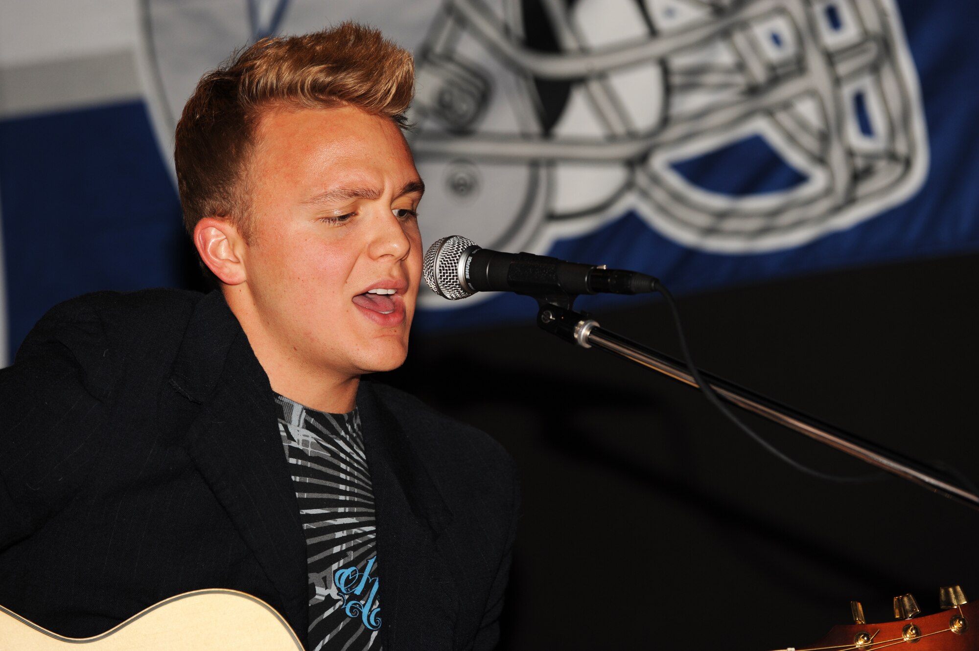 MINOT AIR FORCE BASE, N.D. -- Airman Matthew Swartsfager, 5th Contracting Squadron contracting specialist, performs a song at J.R. Rockers Open Mic Night here June 11. Open Mic Night was presented by the I.M.T. (Improving Morale Together) Committee and featured live performances of poetry and various genres of music. (U.S. Air Force photo by Staff Sgt. Sharida Jackson)