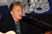 MINOT AIR FORCE BASE, N.D. -- Airman Matthew Swartsfager, 5th Contracting Squadron contracting specialist, performs a song at J.R. Rockers Open Mic Night here June 11. Open Mic Night was presented by the I.M.T. (Improving Morale Together) Committee and featured live performances of poetry and various genres of music. (U.S. Air Force photo by Staff Sgt. Sharida Jackson)