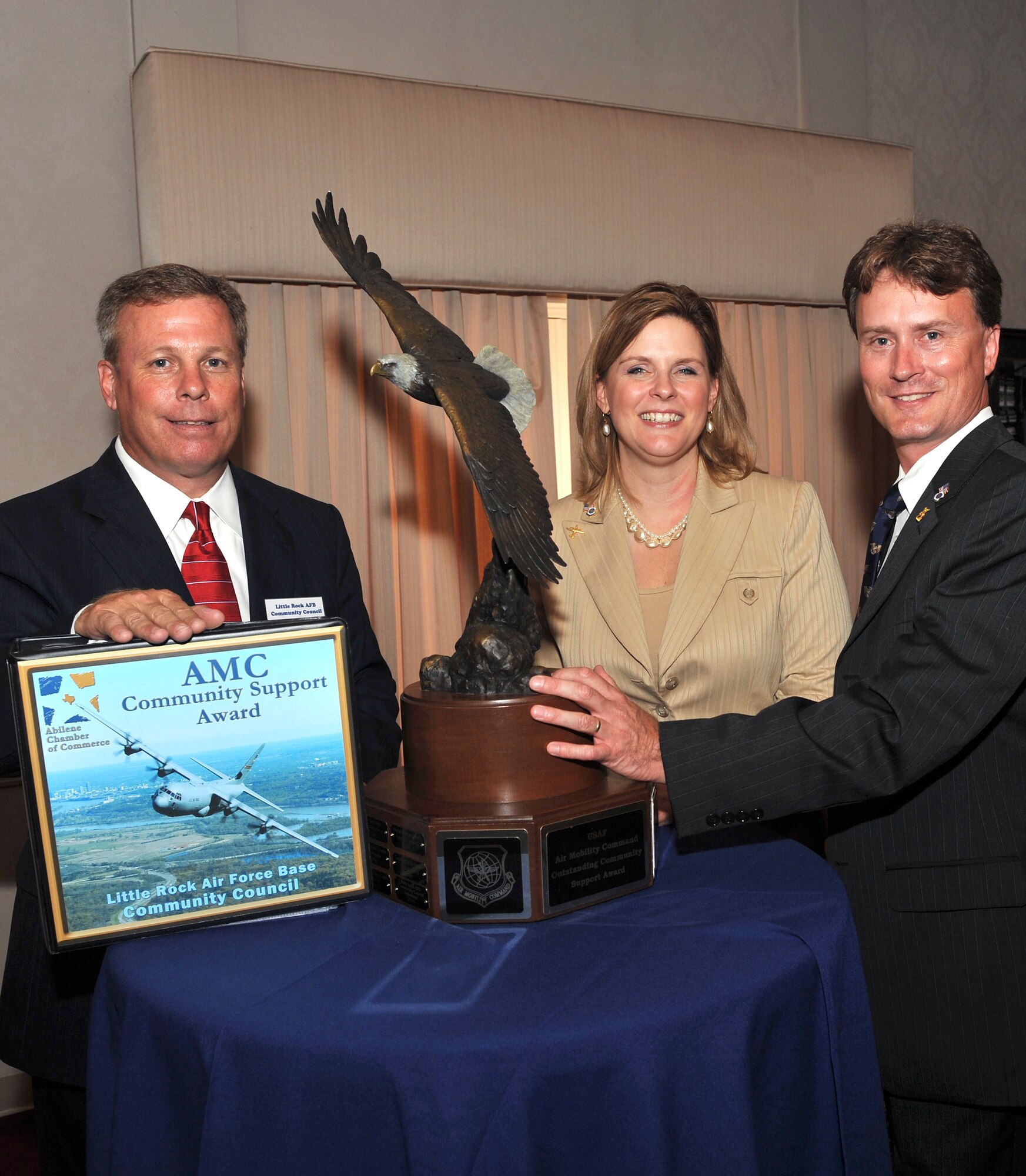 Jay Chesshir (left), Little Rock Air Force Base community council president, is presented the Abilene Trophy June 15 by Gray Bridwell and Kristina Jones, Abilene Chamber of Commerce Military Affairs Committee members.  The prestigious Abilene Trophy is presented annually to the best civilian community with the most outstanding support to a nearby Air Mobility Command base. (U.S. Air Force photo by Senior Airman Chris Willis)