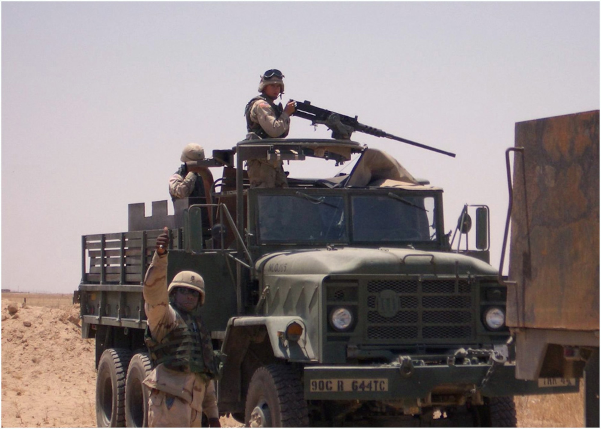 Airmen from the 732nd Expeditionary Logistics Readiness Squadron tow a disabled truck during a supply convoy near Contingency Operating Base Speicher, Iraq, June 2004. (U.S. Air Force photo)